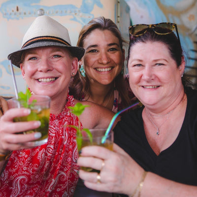 Happy American women from Smitty's Cigar Lounge in Gainesville Georgia share drinks in a Cuban Cocktail Class at La Lore Habana in Old Havana Cuba