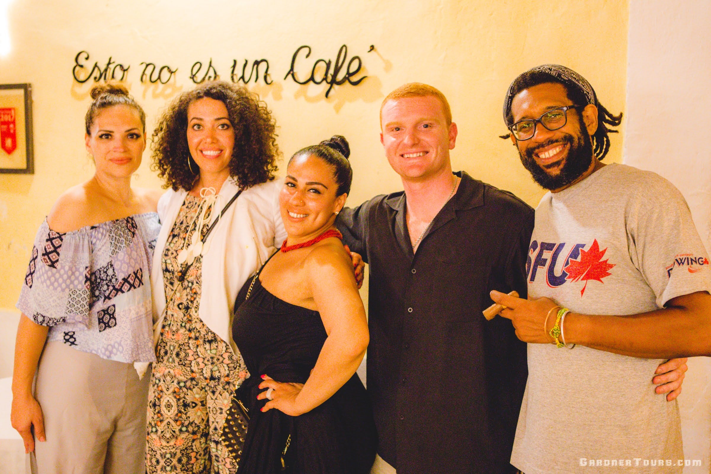 Group of Tourists Taking Picture With Each Other While Holding Cigars at Esto no es un Café in Old Havana Cuba