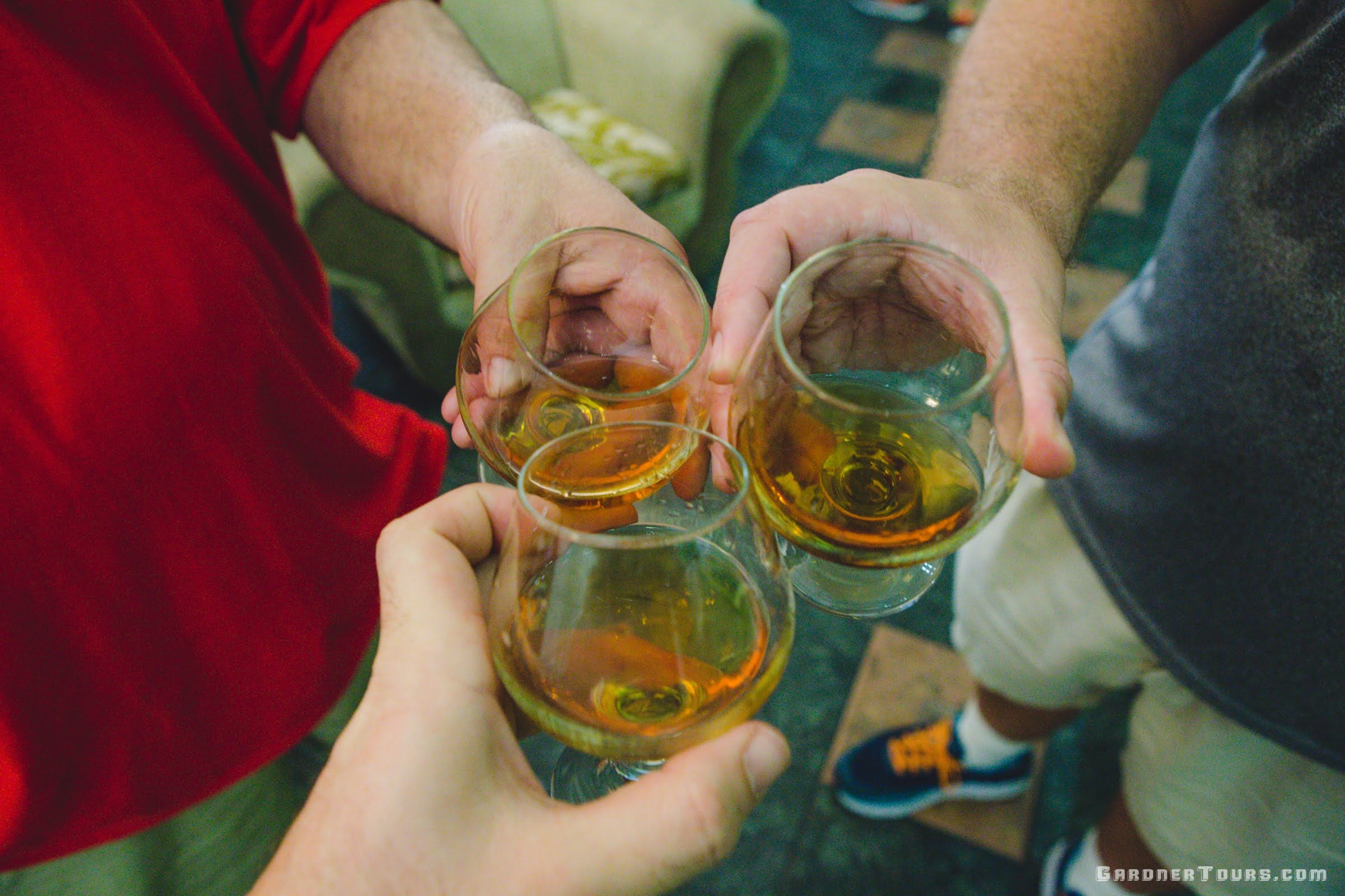Three Friends sharing Santiago de Cuba Rum in Havana, Cuba