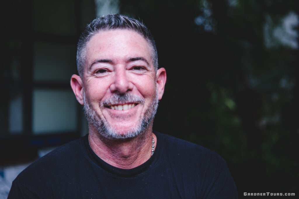 Gardner Tours Cuban Tour Guide Yedi in Black Shirt Smiling Big