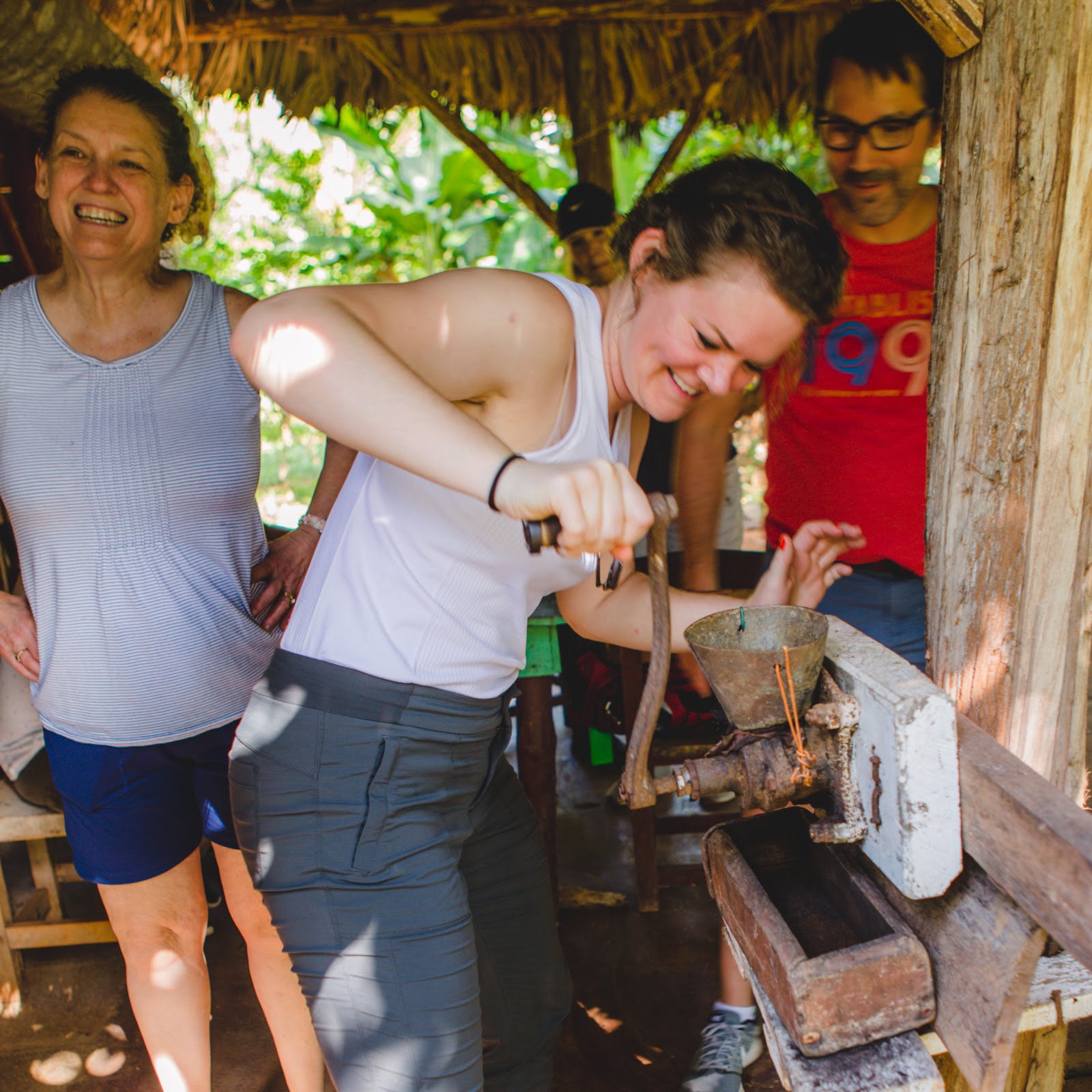 Gardner Tours Custom Cuba Tours Young Woman smiling as she grinds coffee in Vinales Cuba