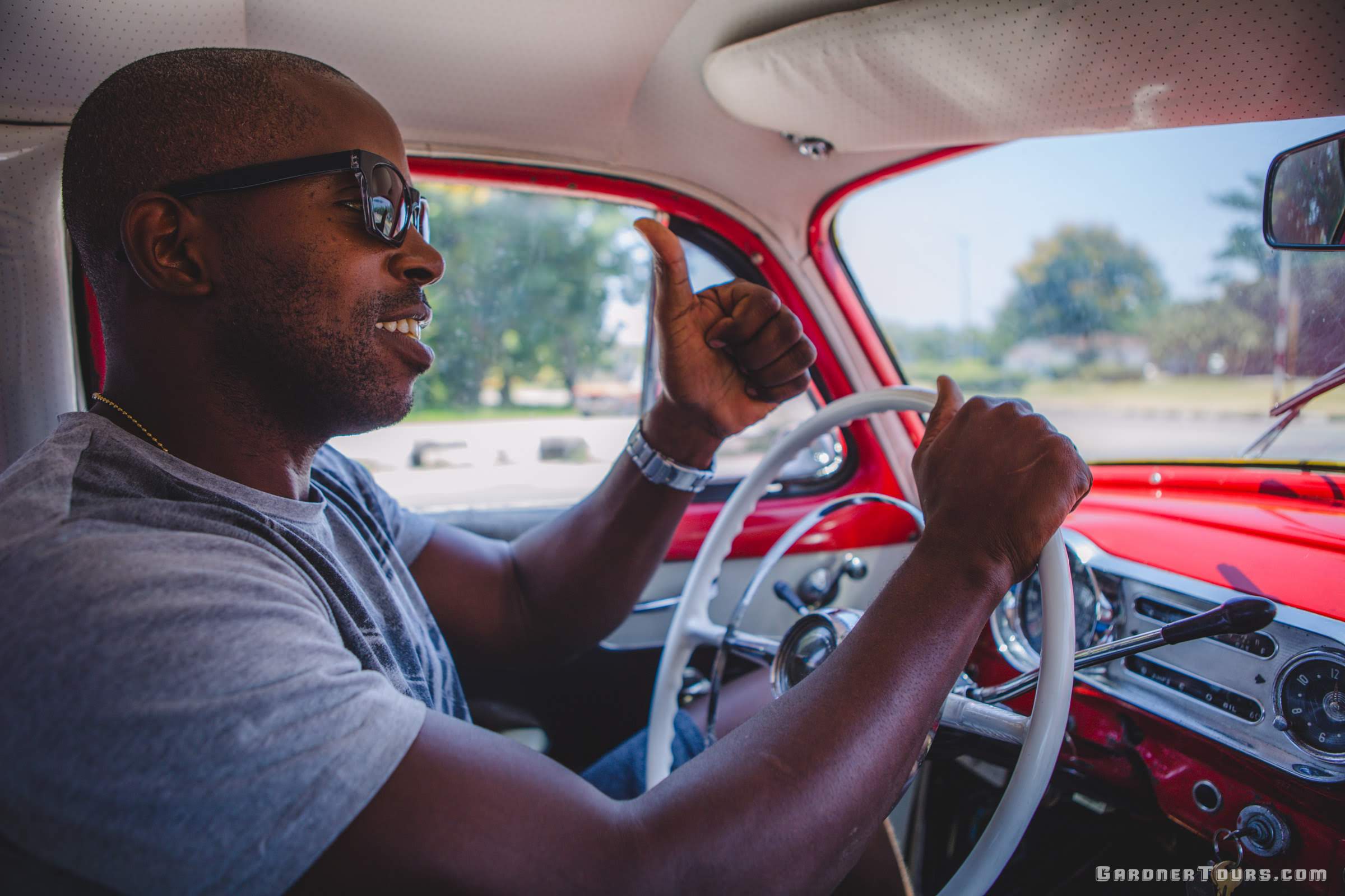 Gardner Tours Custom Cuba Tours Cuban Taxi Driver Michel driving his Classic Car in Havana Cuba