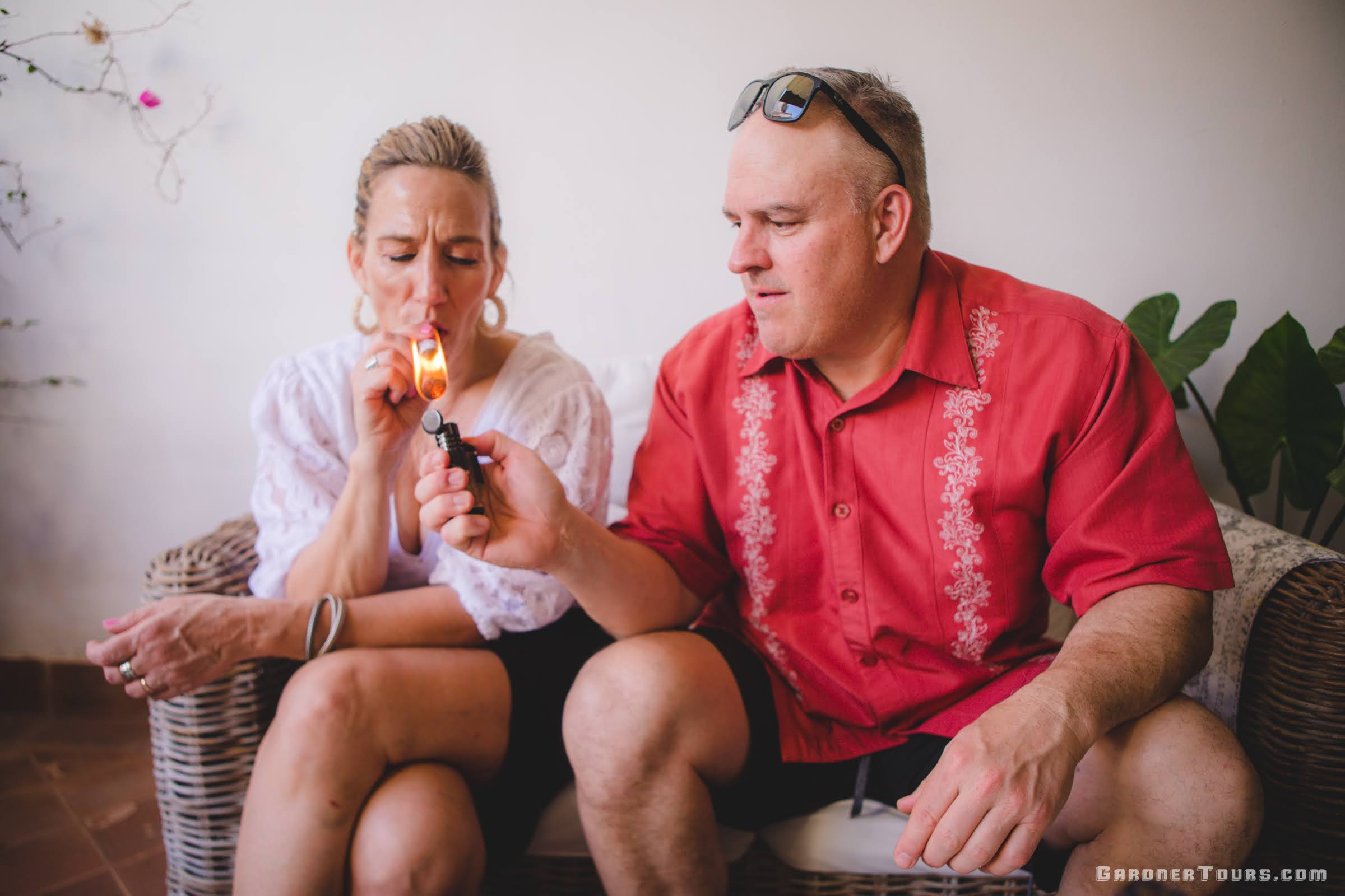 Dawn and Scott Nangle American Travelers on a Luxury Cuba Tour lighting a cigar before an evening out in Old Havana, Cuba