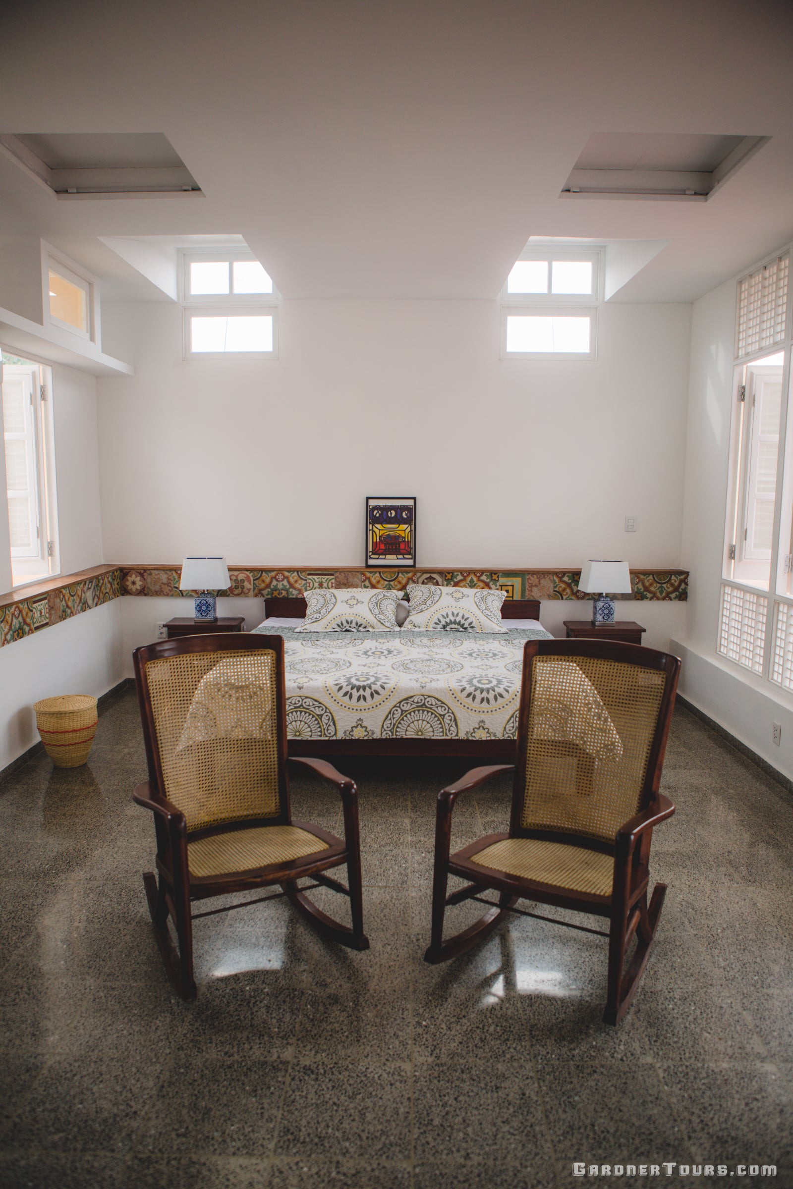 Gardner Tours spacious king size bed in a rooftop room with white walls and classic tiles at a 4-star BnB Casa Particular in Old Havana, Cuba