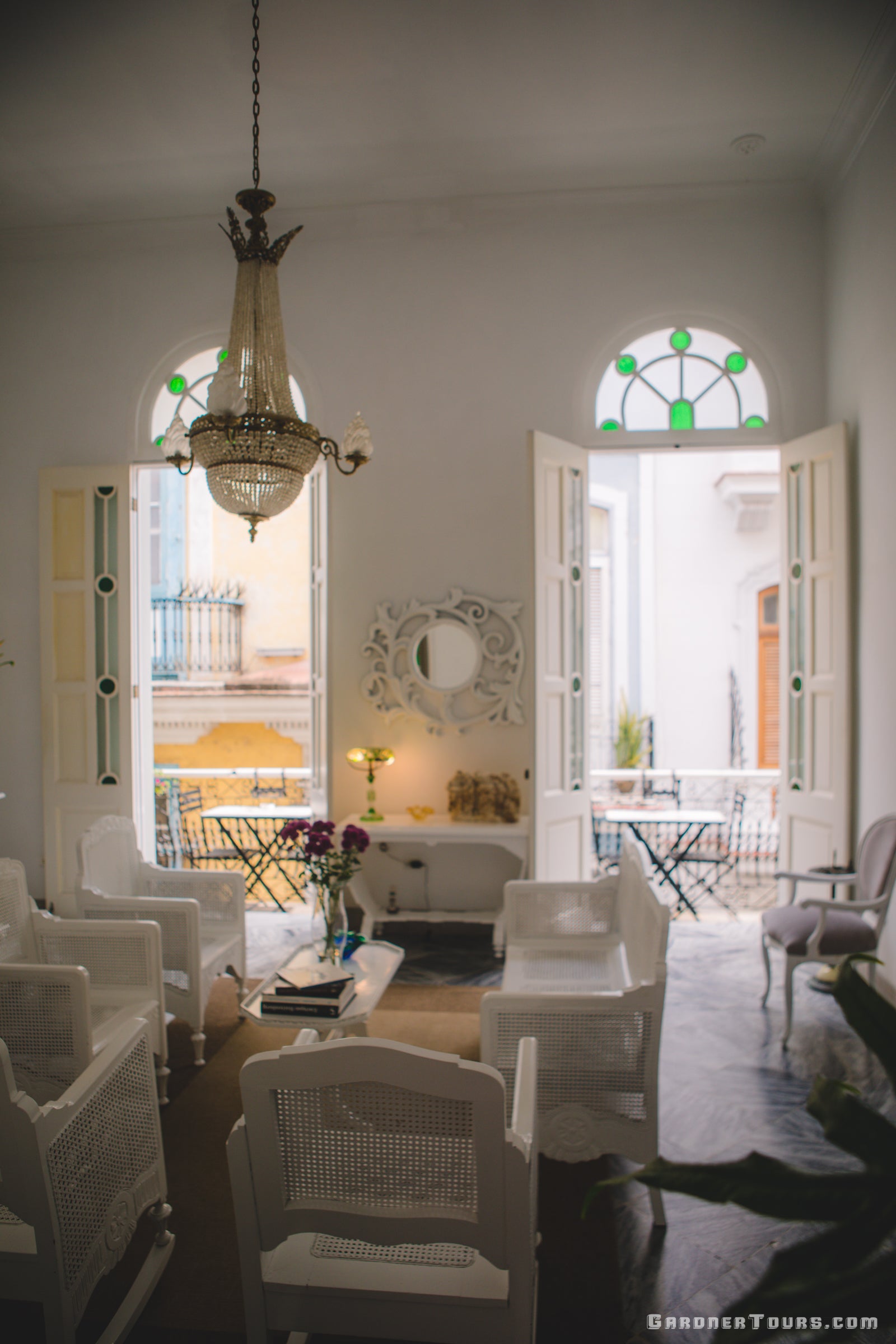 Second Floor Living Room with White Chairs, Beautiful Chandelier and Stained Glass in 4-Star BnB in Old Havana, Cuba
