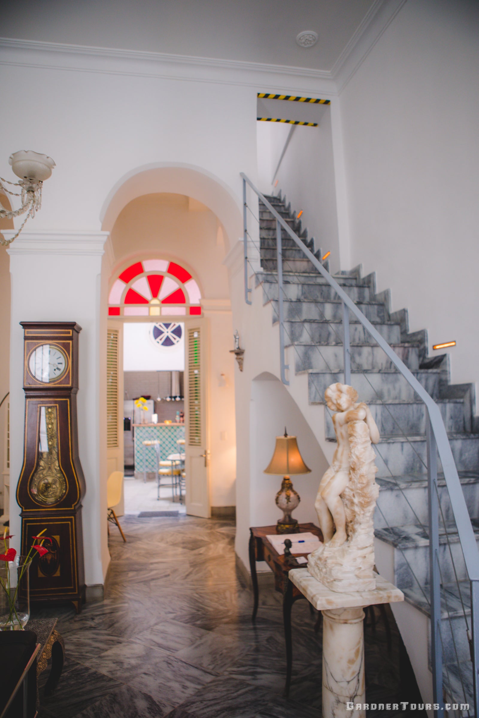 Living Room with Marble Staircase and Grandfather Clock in 4-Star BnB in Old Havana, Cuba