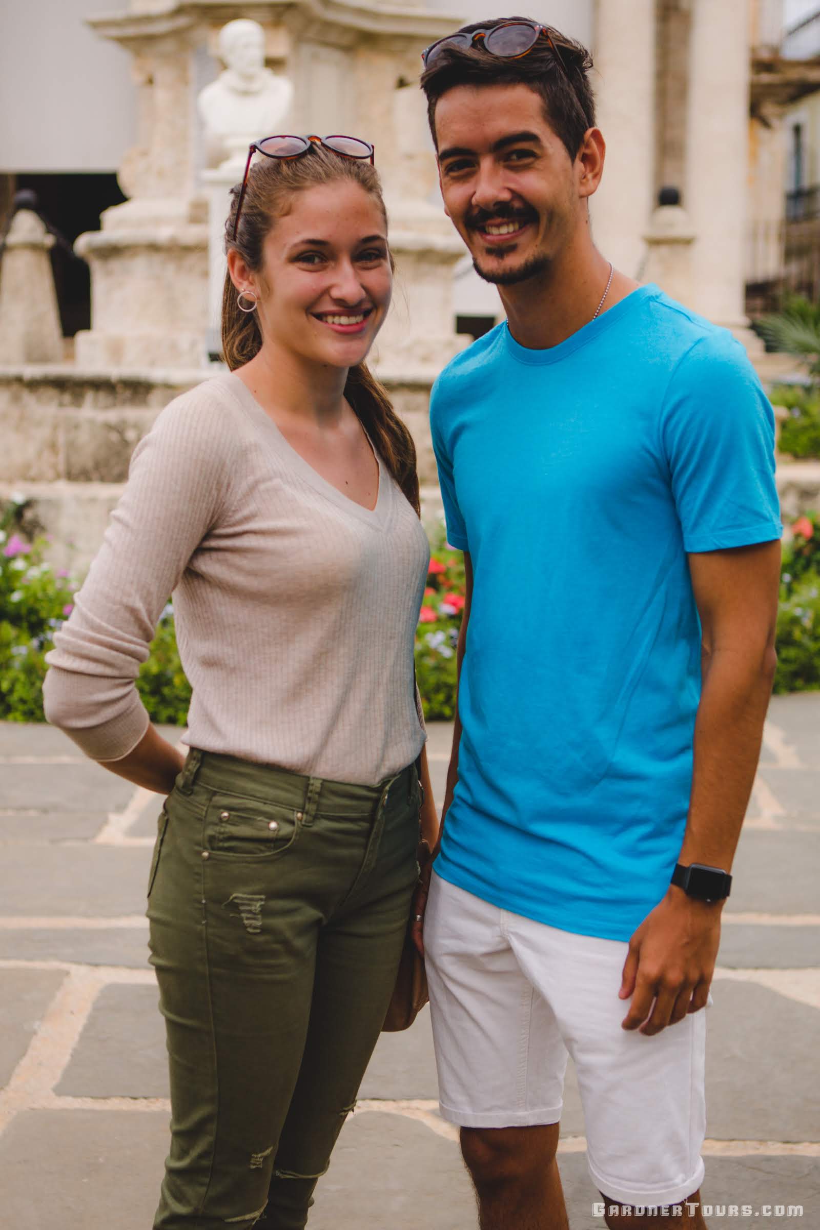 Gardner Tours Cuban Tour Guide Camila Posing with her boyfriend in front of El Templete in Plaza de Armas in Old Havana, Cuba