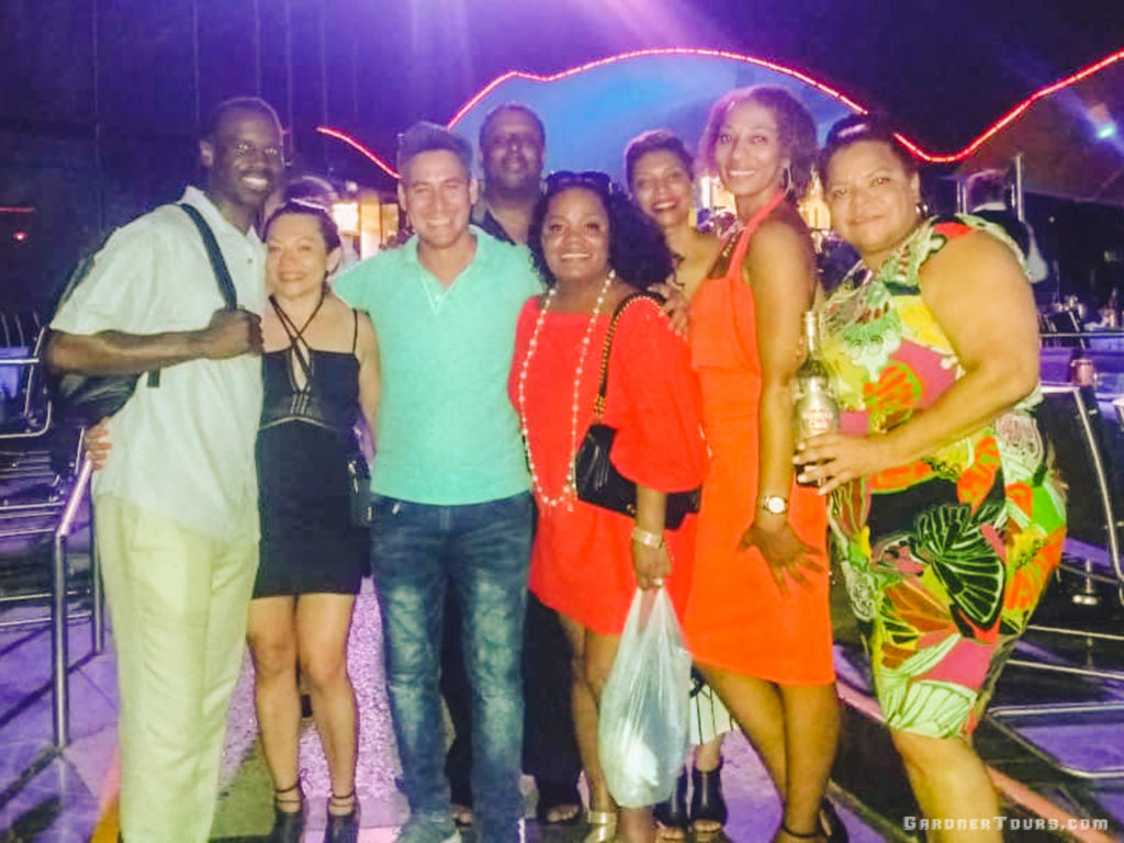 Gardner Tours Cuban Tour Guide Carlos with his travelers smiling big after a big show at the Tropicana Cabaret in Havana, Cuba
