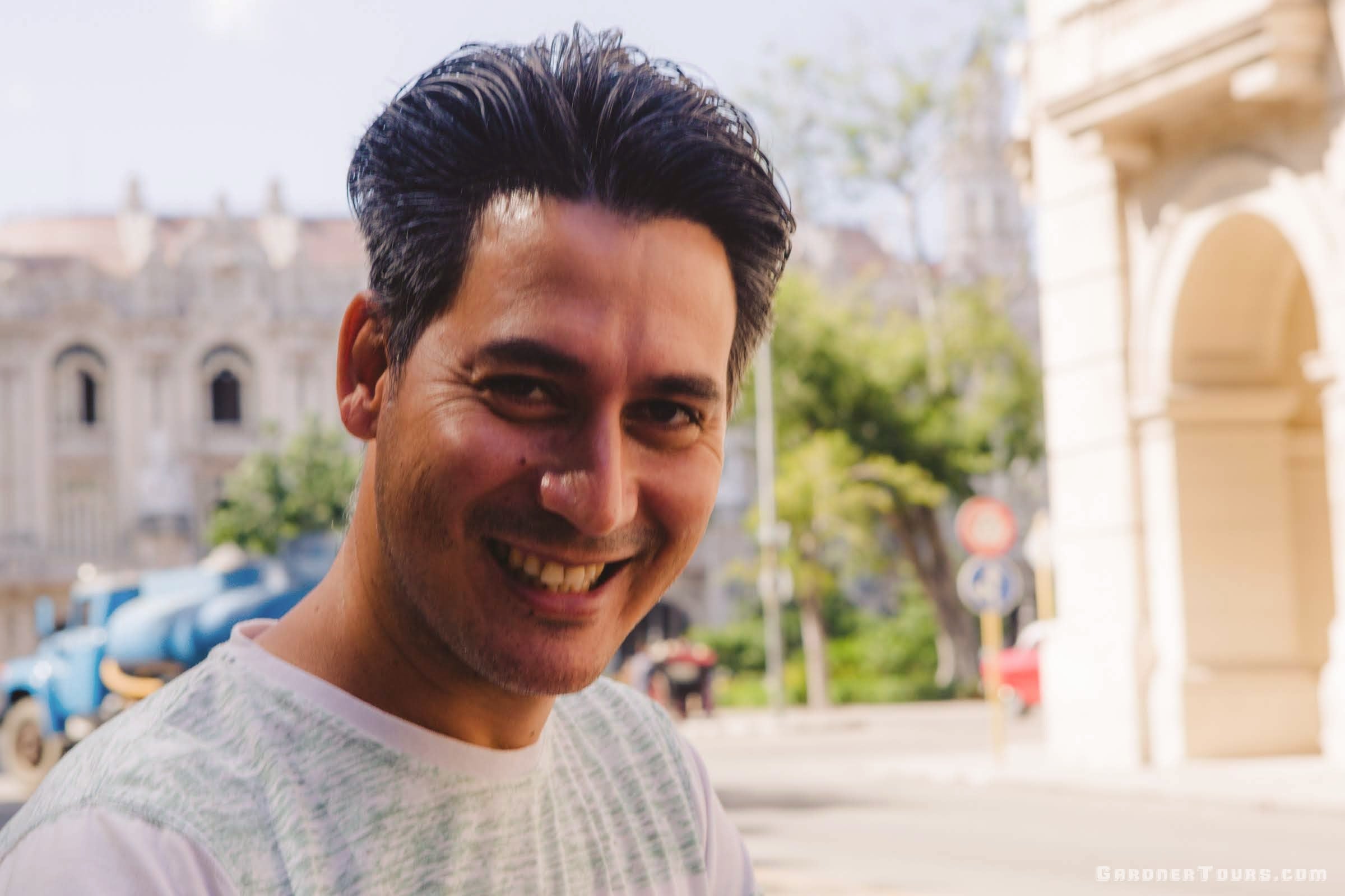 Gardner Tours Cuban Tour Guide Carlos smiling big in the streets of Old Havana, Cuba