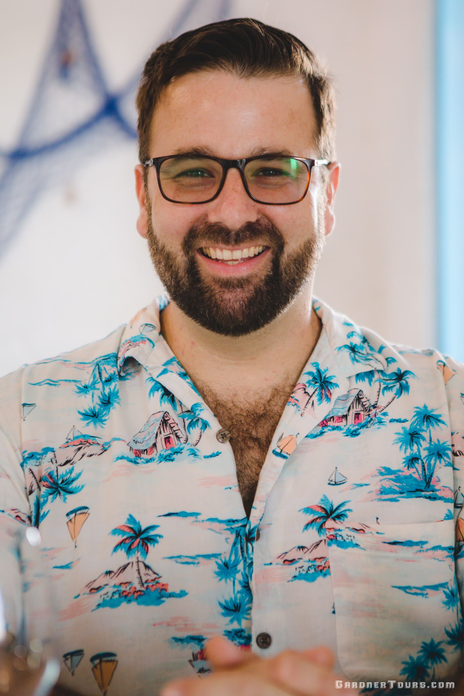 Gardner Tours Owner and Tour Guide Colby Gardner in a pretty tropical shirt smiling at dinner in Havana, Cuba