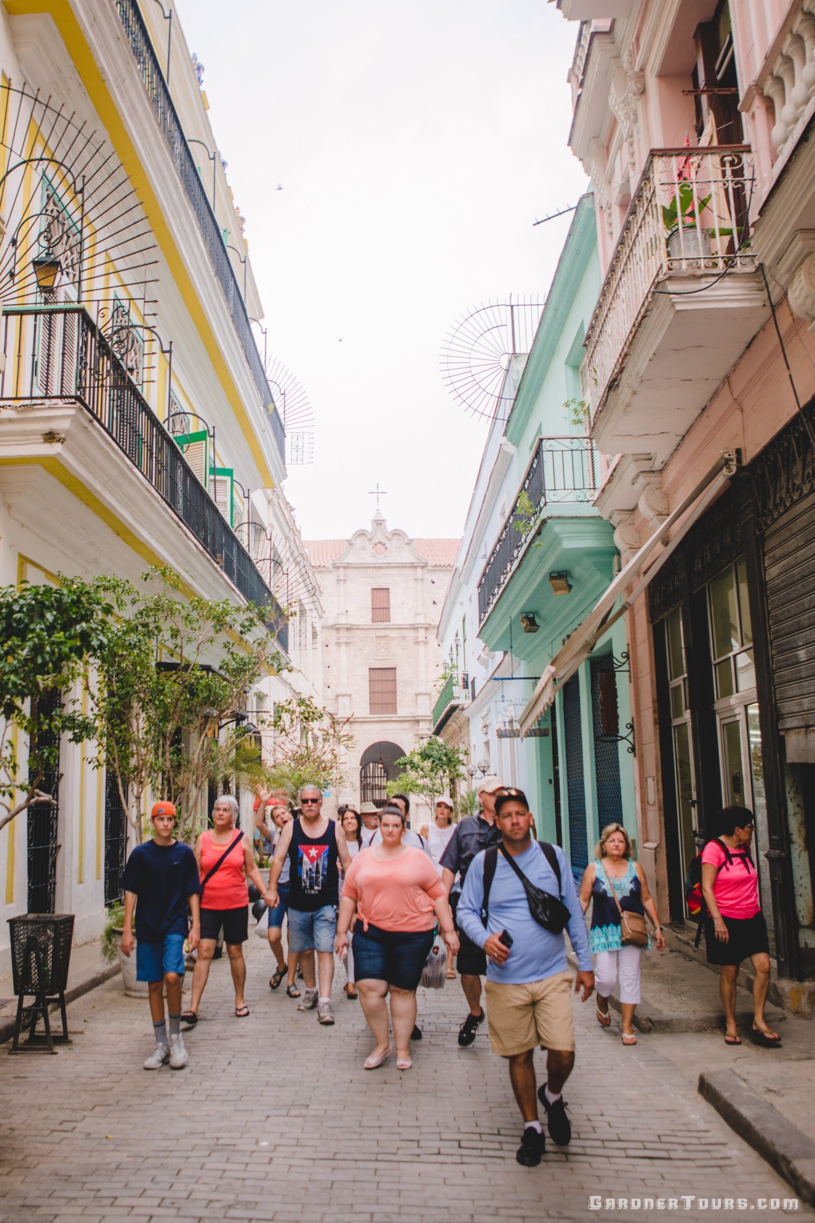 Gardner Tours Cuban Tour Guide Yunior leading a group of travelers from the Convent of San Francisco de Asis to Plaza Vieja in Old Havana, Cuba