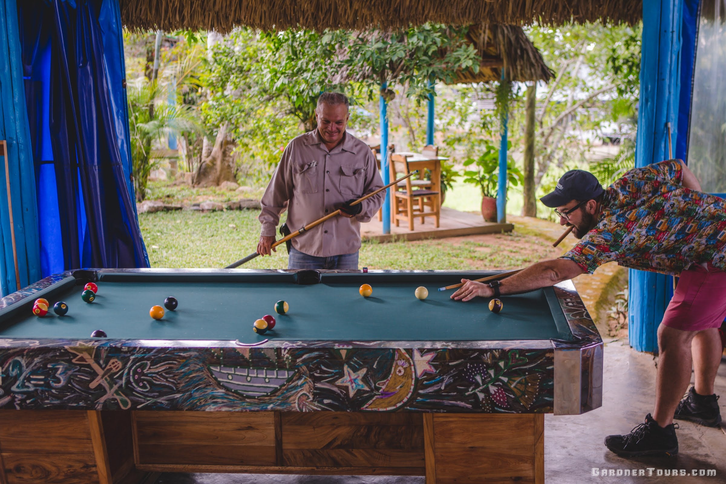Gardner Tours Owner and Tour Guide Colby Gardner playing billiards with Hector Luis Prieto Hombre del Habanos at his farm Quemado del Rubí in Pinar del Rio, Cuba