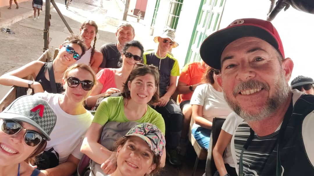 Gardner Tours Cuban Tour Guide Yedi riding in a truck with a group of travelers