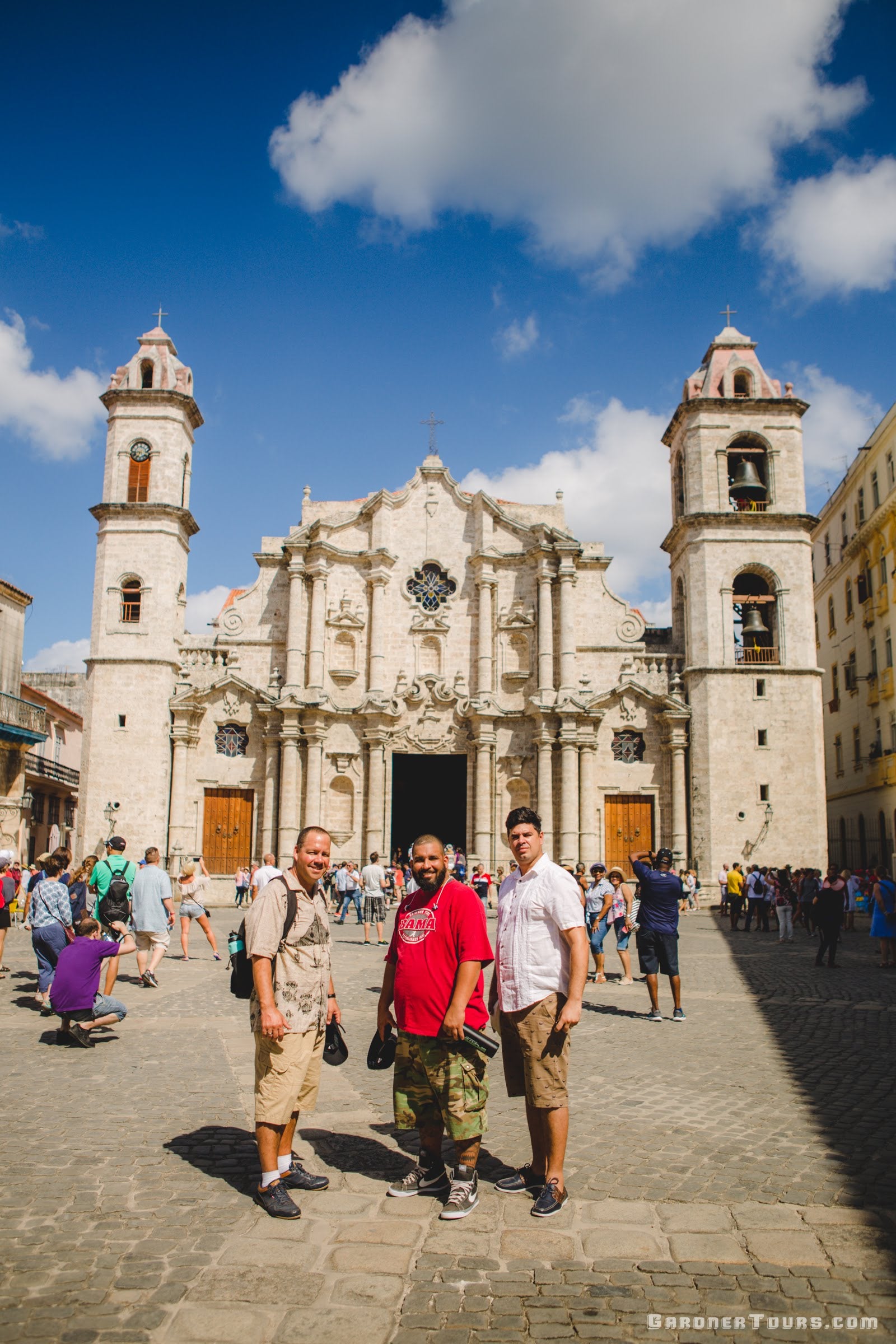 Gardner Tours Cuban Tour Guide Albert posing with friends in front of the Cathedral of Havana in Old Havana, Cuba