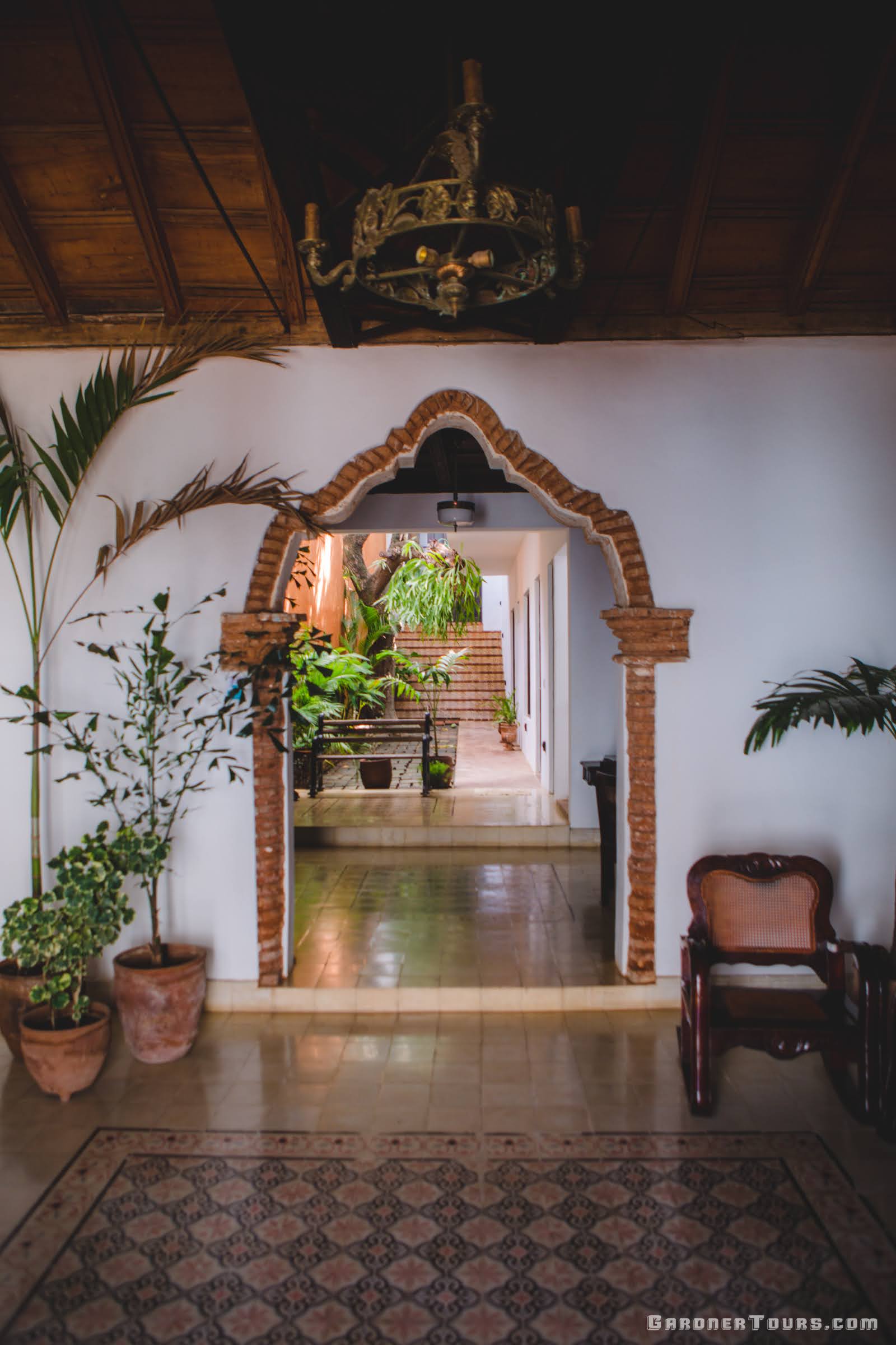 Cuba Luxury Tours Spacious Entryway with an ornate brick doorway at Jesus Maria 432 in Trinidad, Cuba