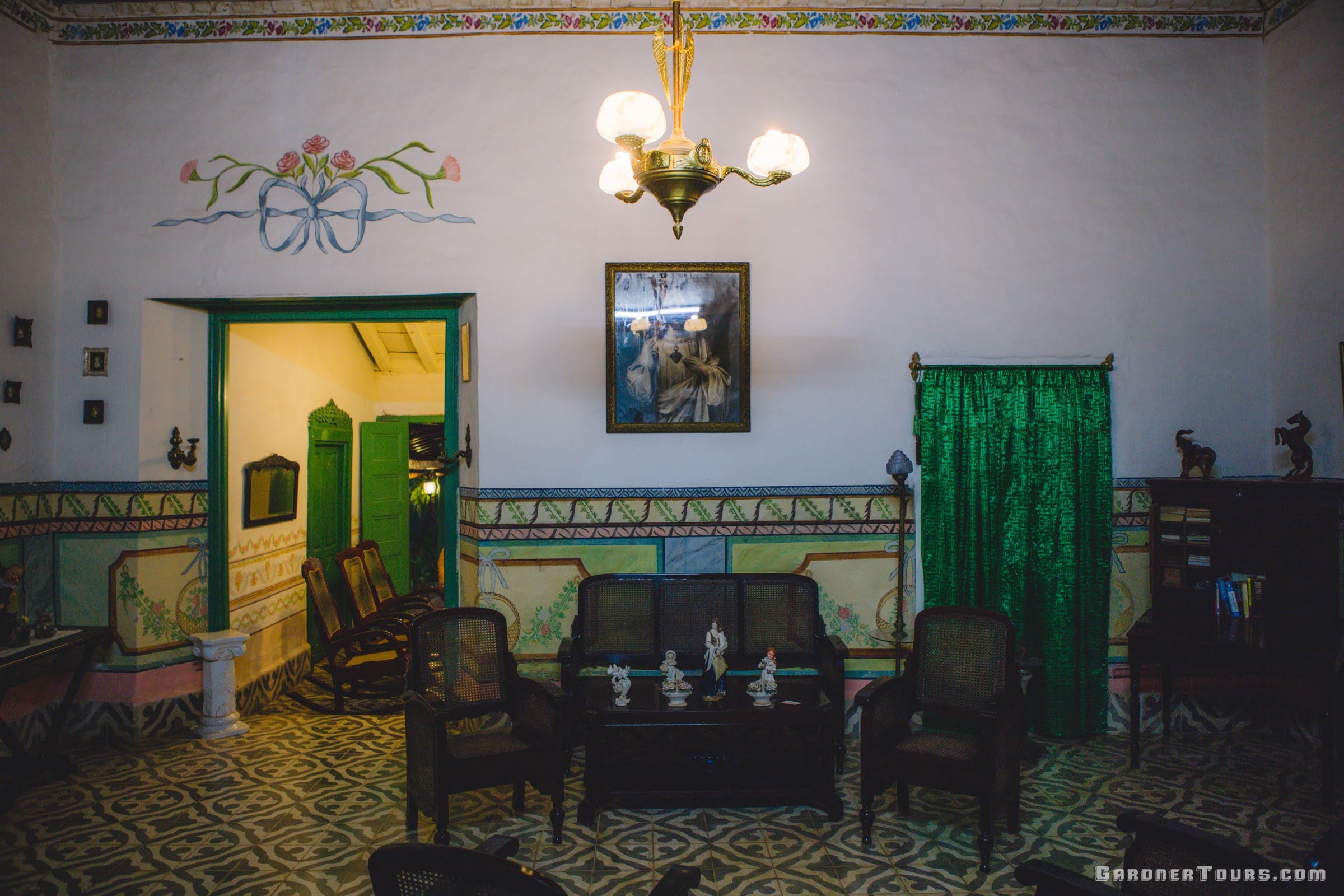 Classic 1700s colorful green and white Living Room Sala in a 3-star Casa Particular BnB in Trinidad, Cuba