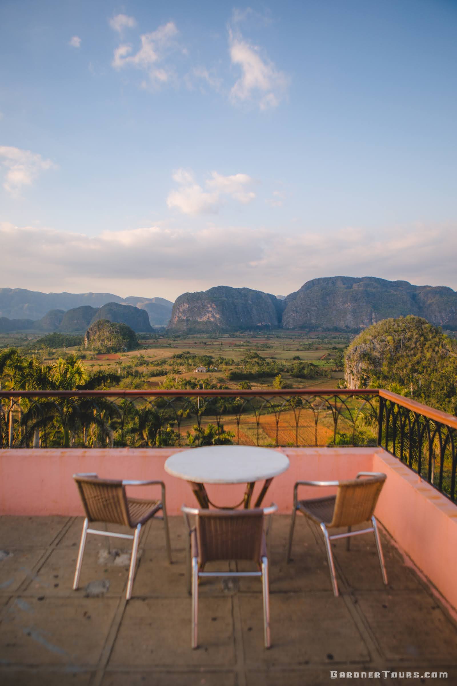 A private balcony overlooking a lush valley, representing the boutique hospitality of Gardner Tours in Cuba, Guatemala, and Texas.