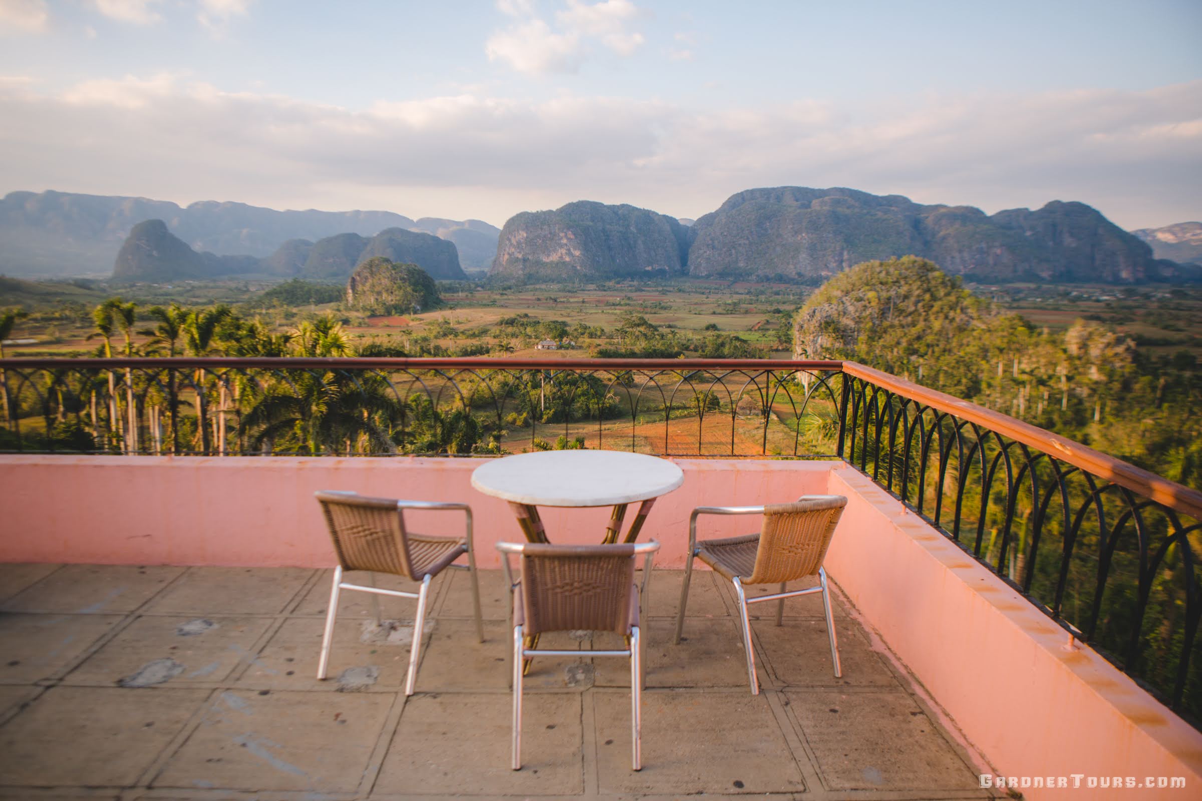 A private balcony overlooking a lush valley, representing the boutique hospitality of Gardner Tours in Cuba, Guatemala, and Texas.