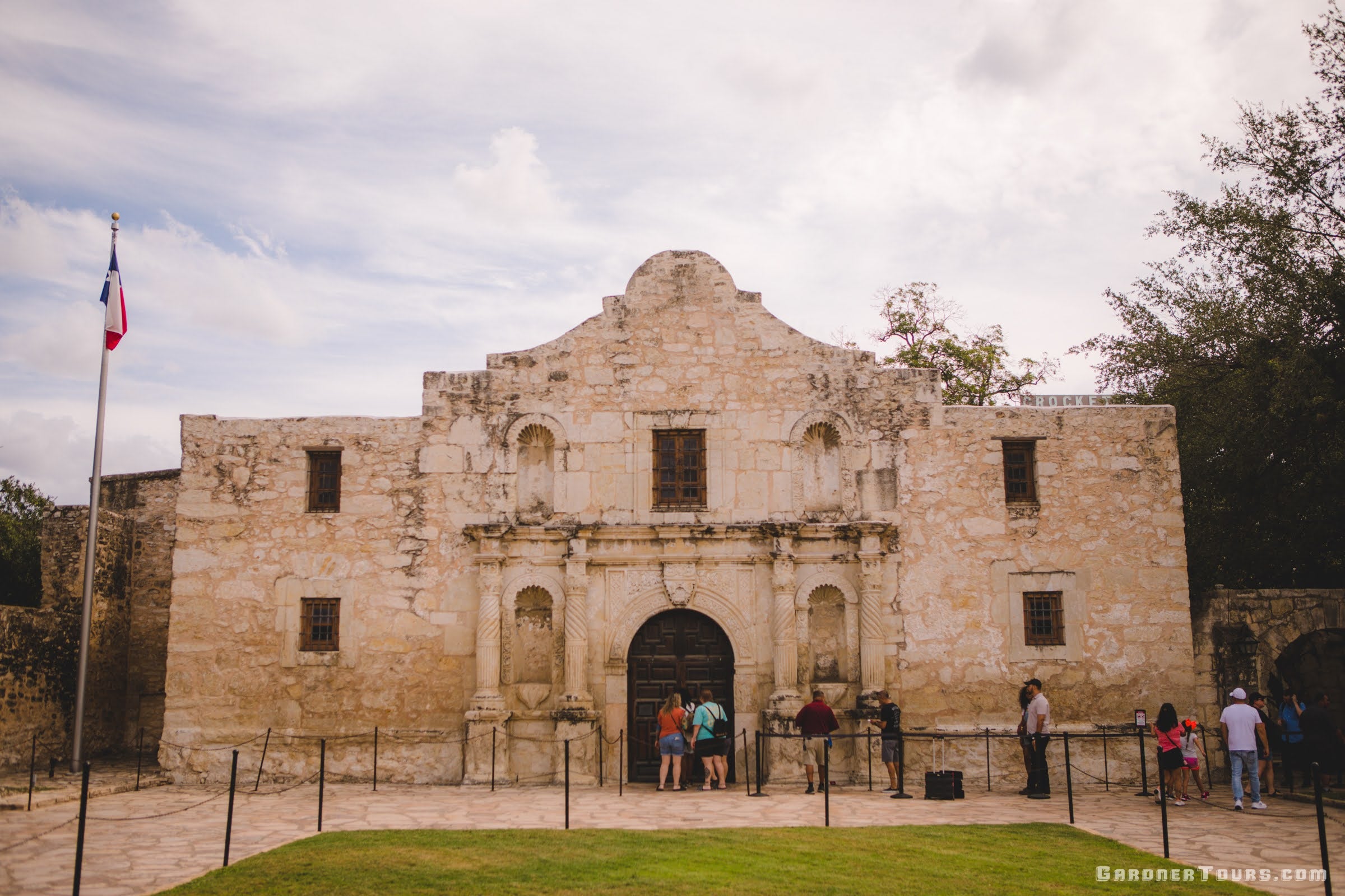 The Alamo with people visiting on a cloudy day