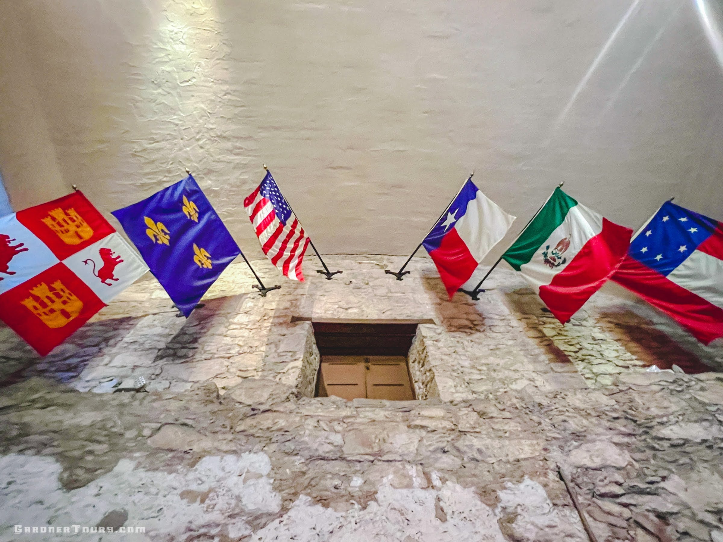 The six flags over Texas hanging inside the Alamo in San Antonio, representing the six nations that have ruled Texas.