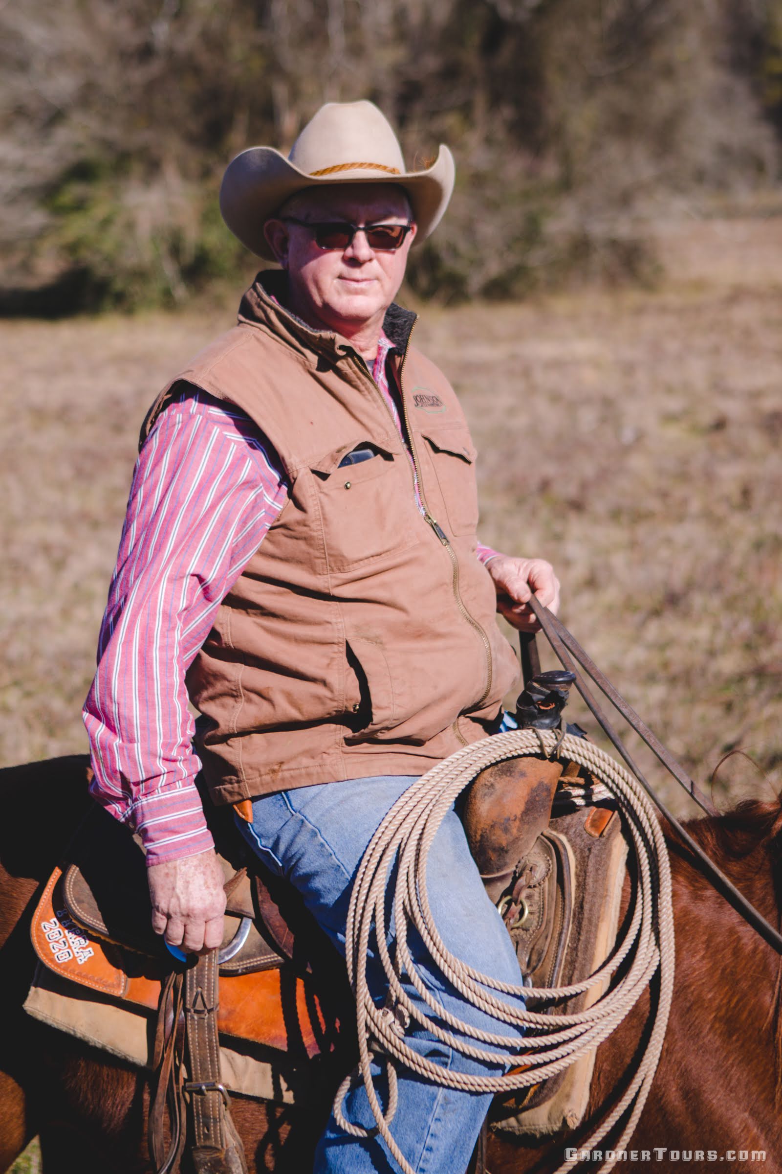 Close-up of an older cowboy riding his horse on a ranch outside Centerville, Texas.