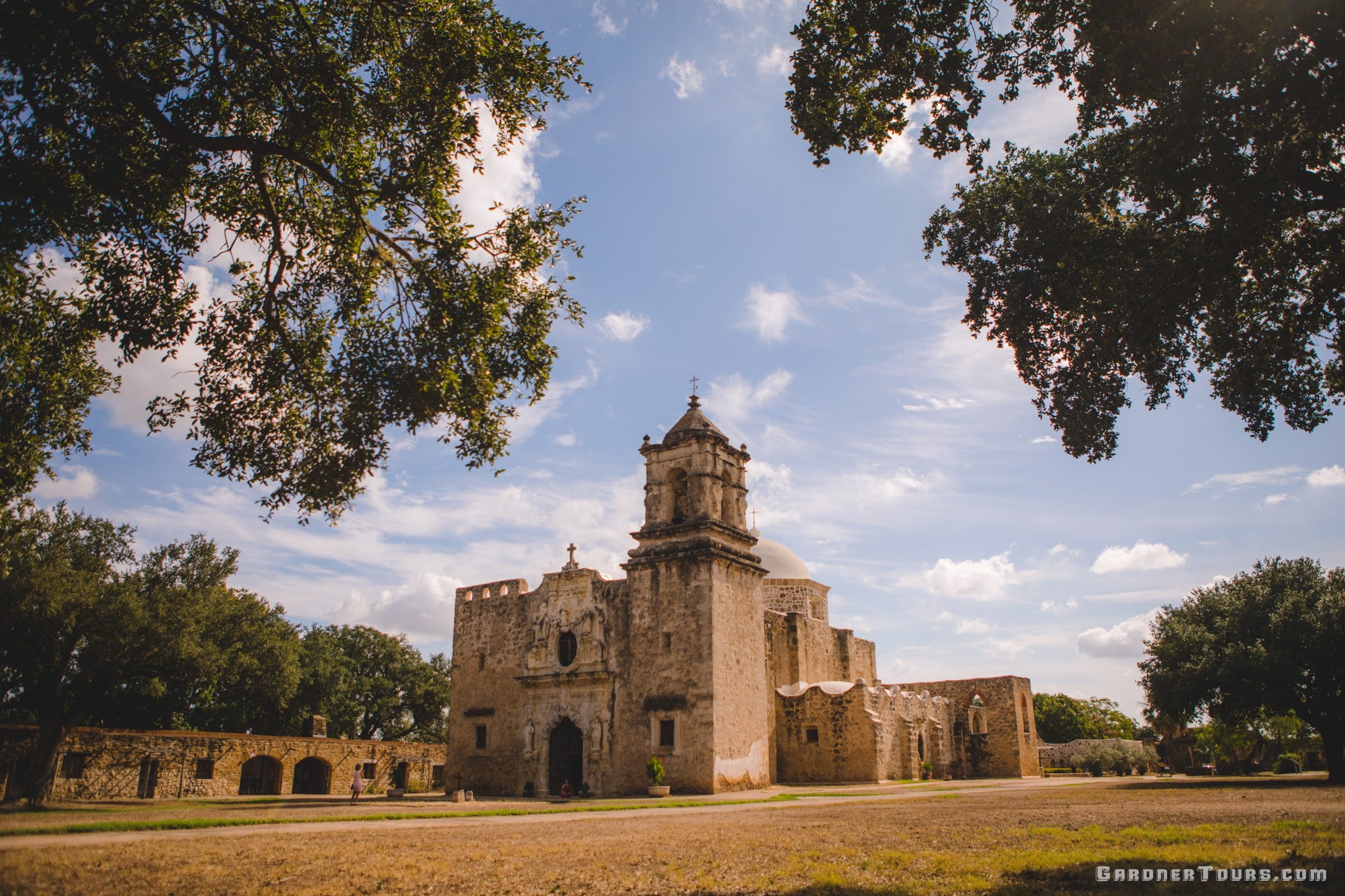 View of the historic Mission San José in San Antonio from under the oak trees.