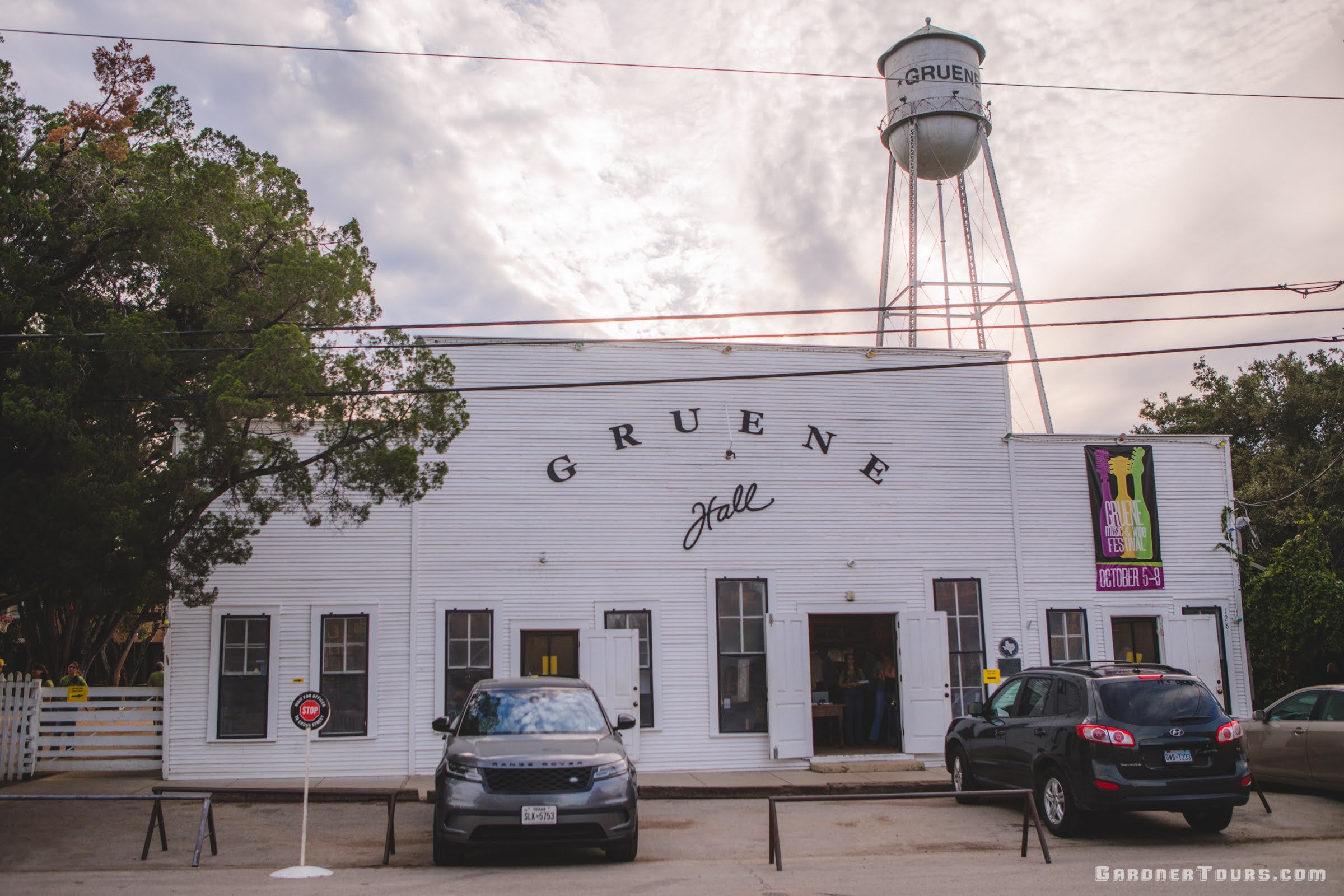 Gruene Hall building with a water tower in the background