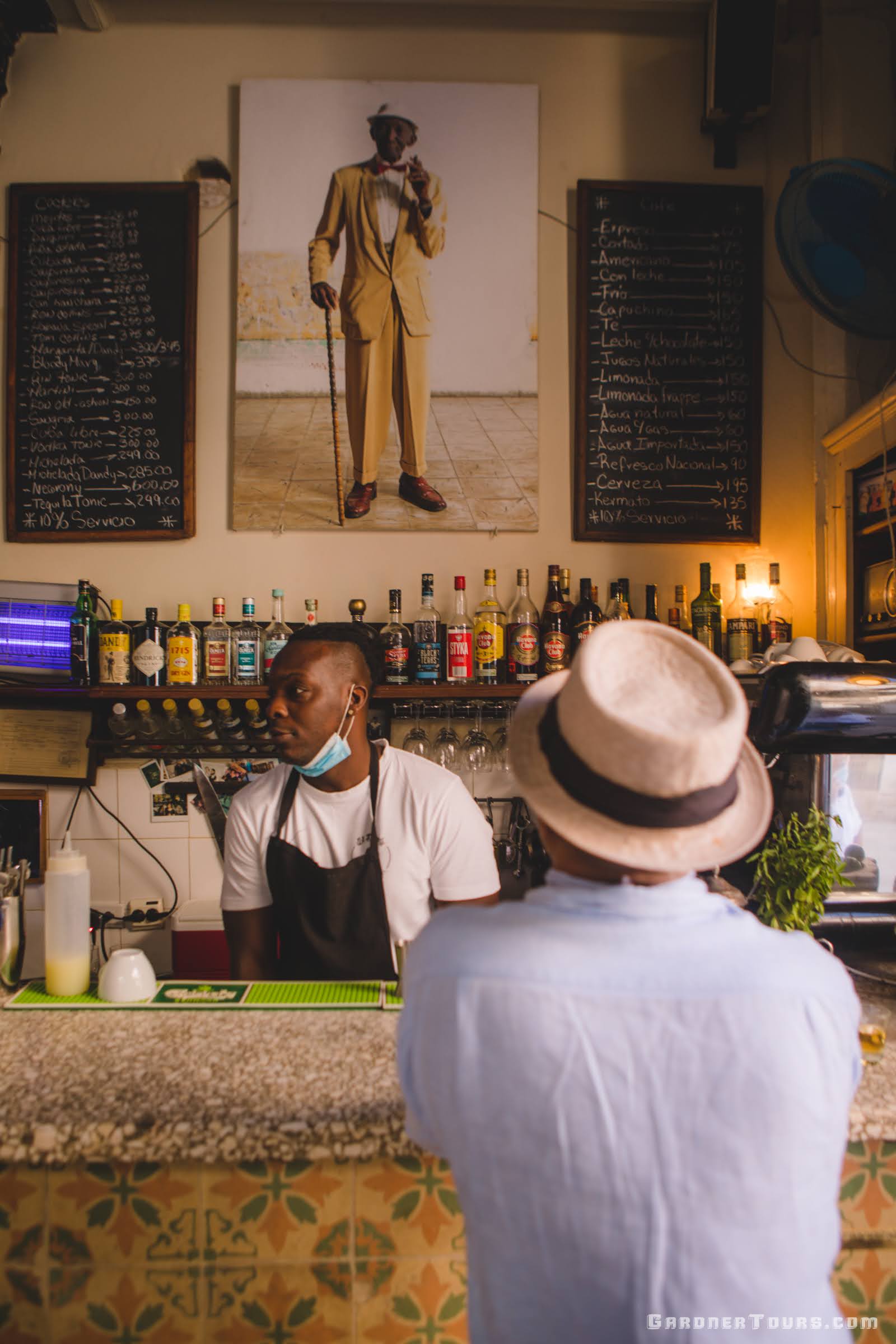 Bar Tender Serving Drinks At El Dandy Bar In Old Havana Cuba