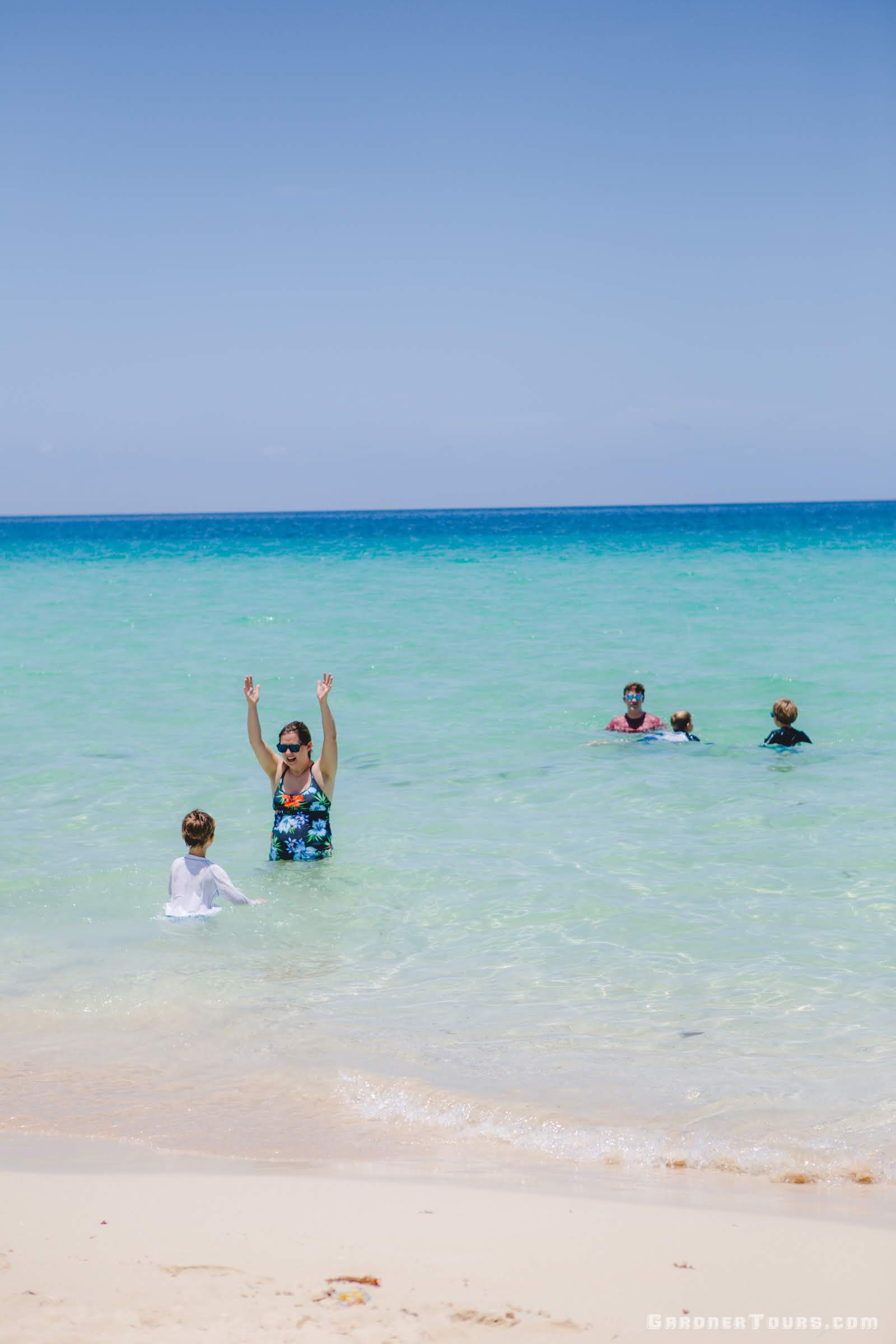 Family Playing in the water at the Playas del Este Beach Outside of Havana, Cuba