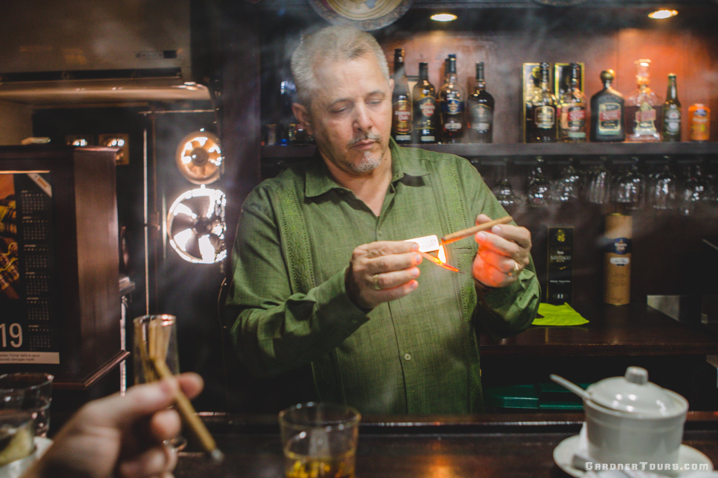Man Lighting a Cigar at Cuba's Oldest Cigar Shop in Hotel Condede Villanueva Cigar Shop in Havana, Cuba