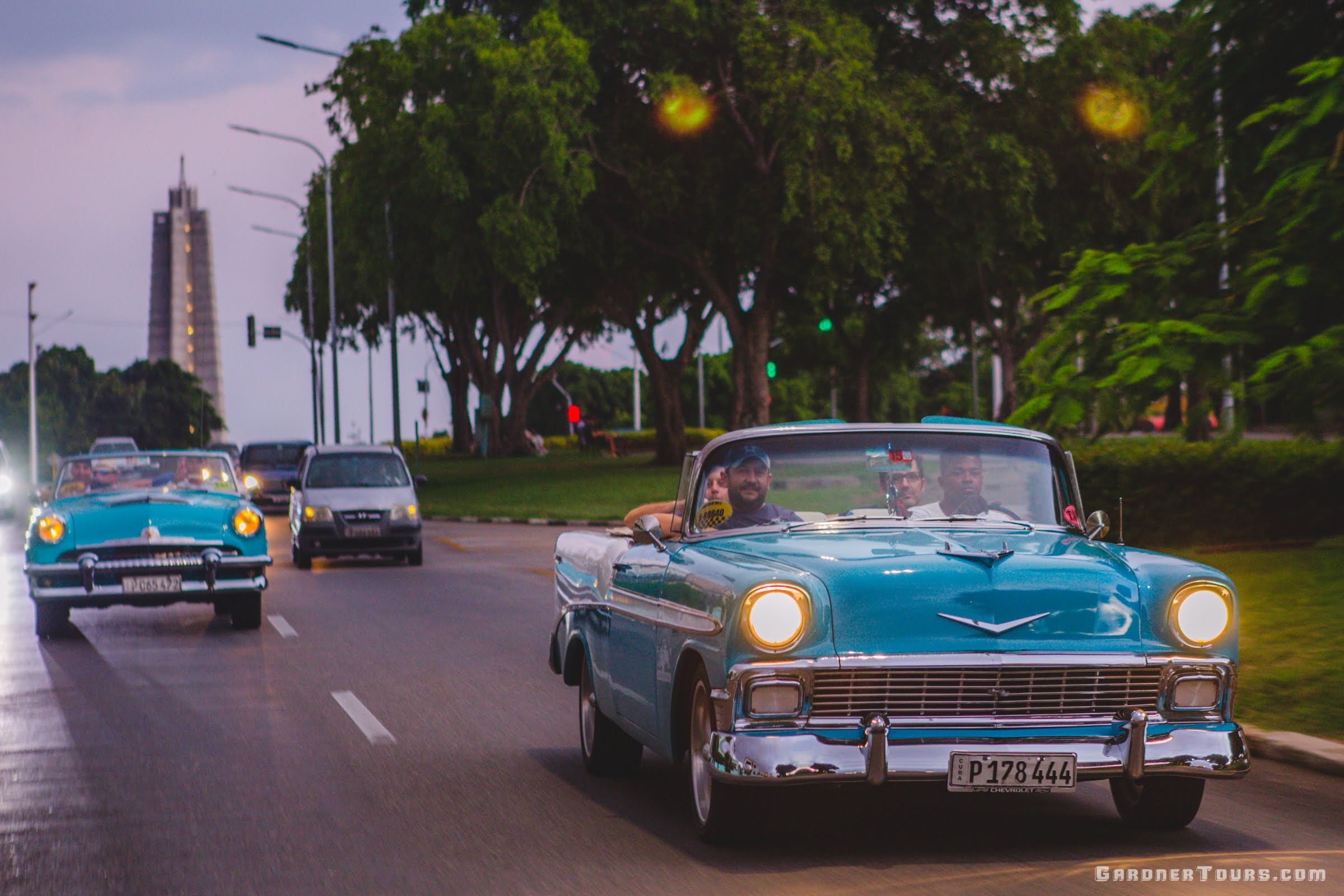 Friends Riding through Vedado in Classic Cars in Havana, Cuba
