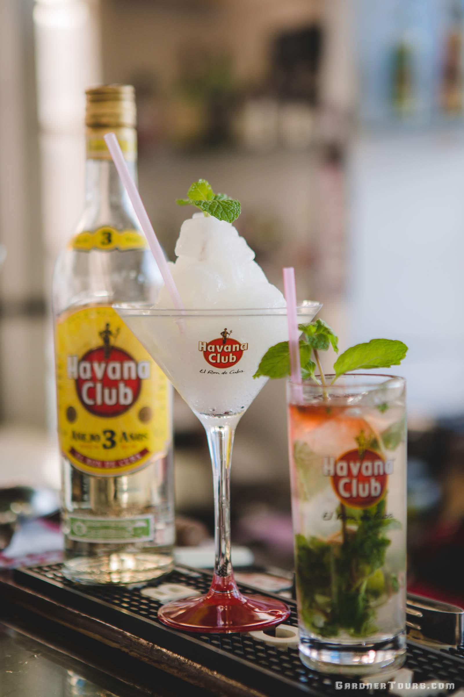 A Frozen Daiquiri, a Mojito, and a Bottle of Havana Club 3 Year White Rum on a Rooftop during a Cuban Cocktail Lesson in Old Havana, Cuba