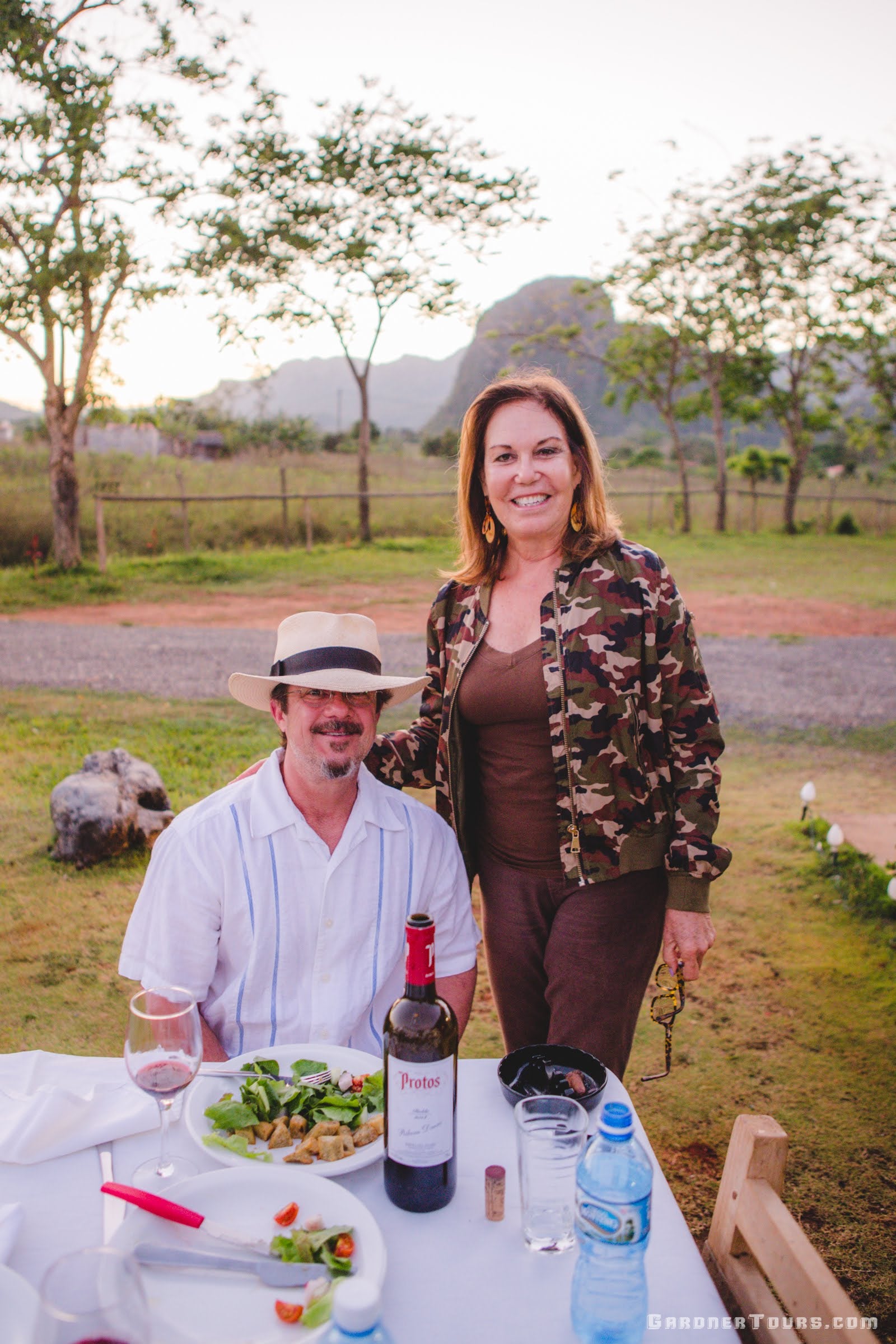 Man and a Woman enjoying a nice meal with wine at 5-Star Restaurant Paladar El Cuajaní in Viñales, Cuba
