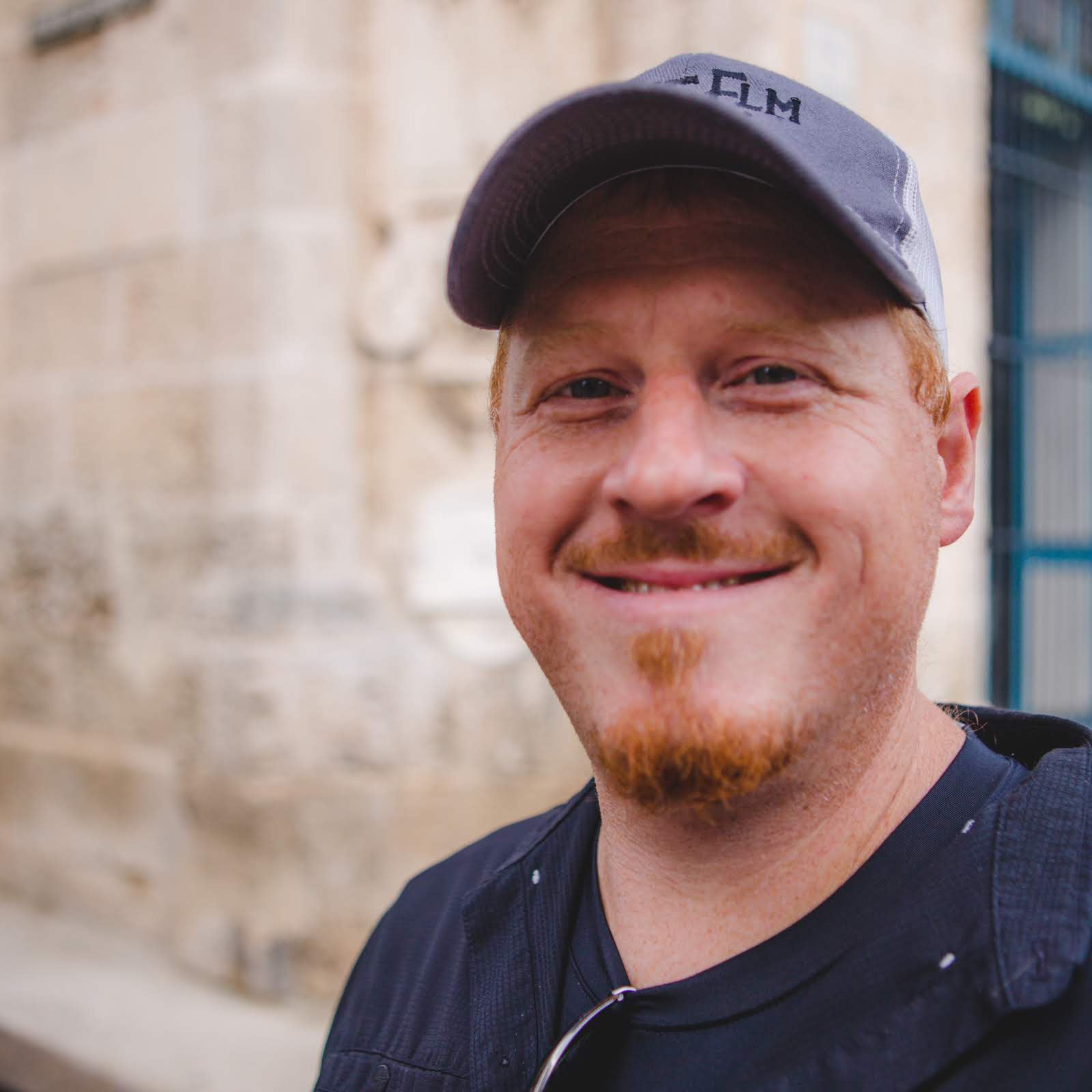 Gardner Tours Custom Cuba Tours Red Headed Man smiling in the Plaza of the Cathedral in Old Havana, Cuba