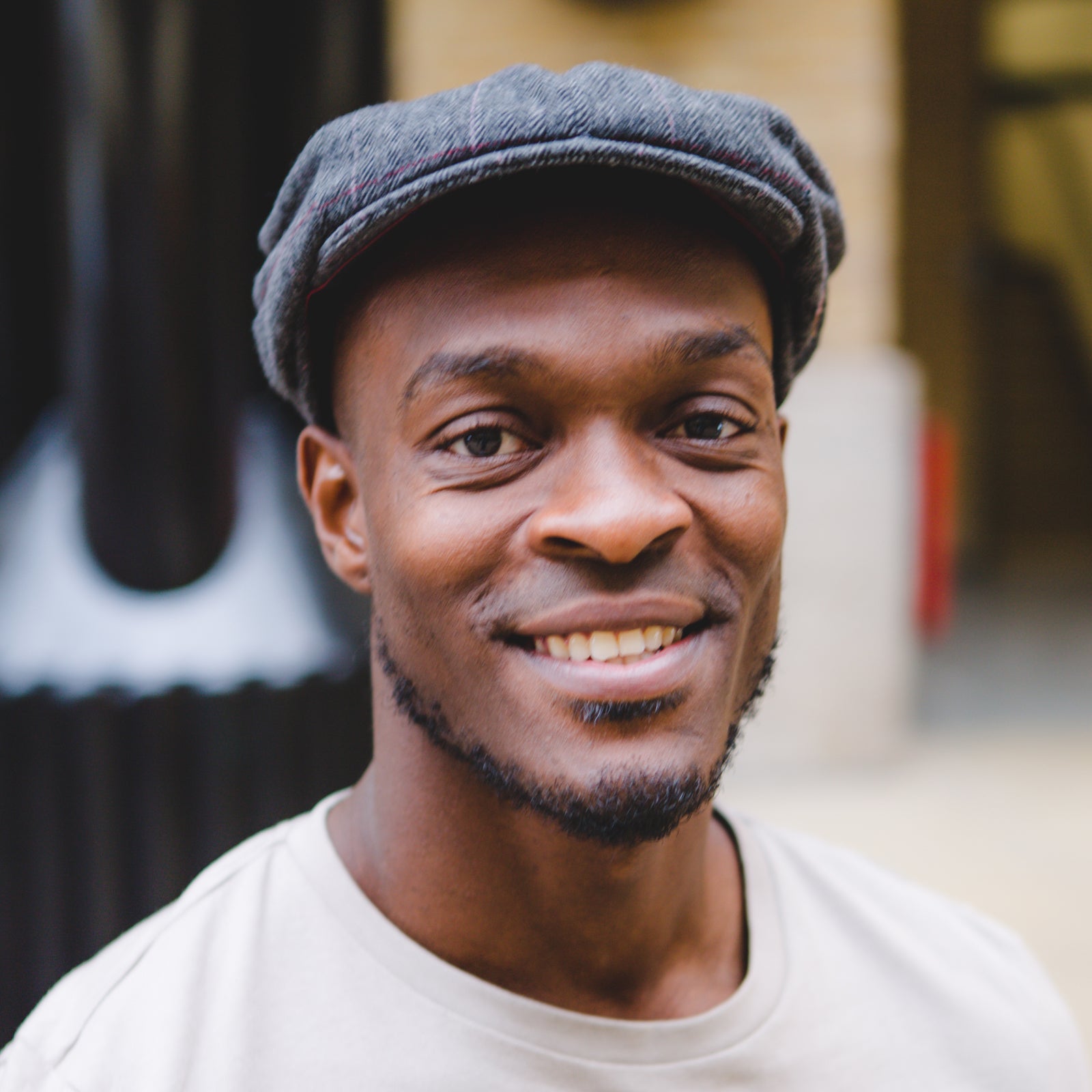 Gardner Tours Custom Cuba Tour Young Black Man with a Grey Hat Smiling