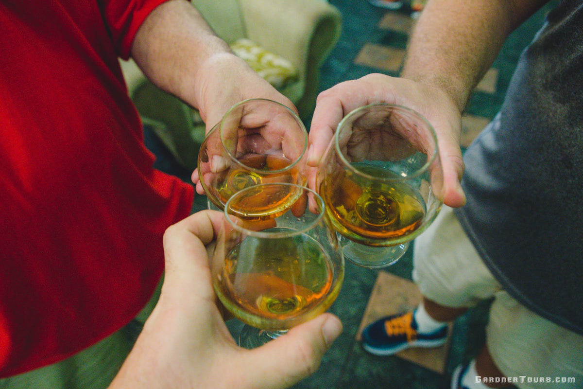 Three Friends sharing Santiago de Cuba Rum in Havana, Cuba