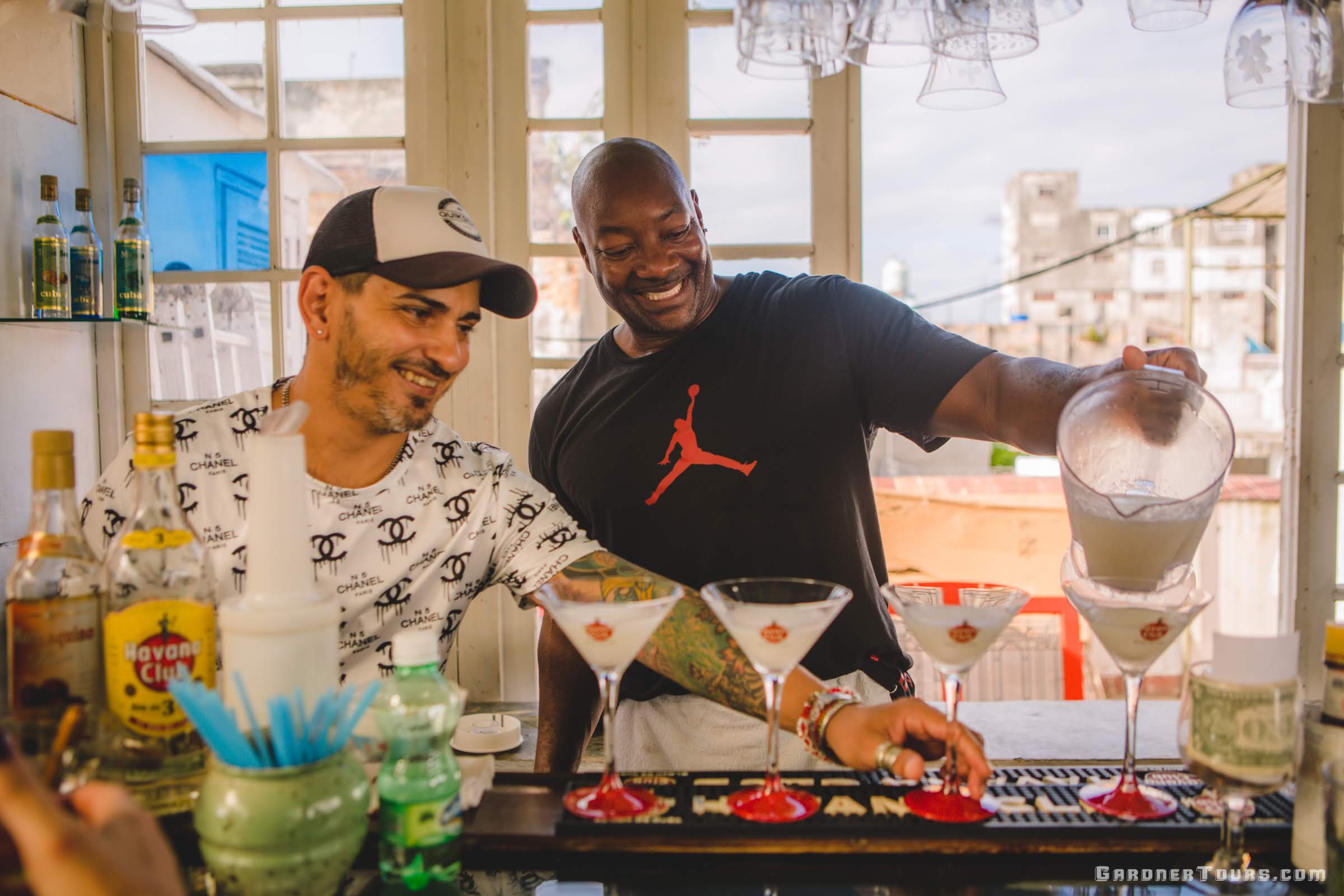 Two men Pouring Cuban Cocktails at Rooftop Bar in Havana, Cuba