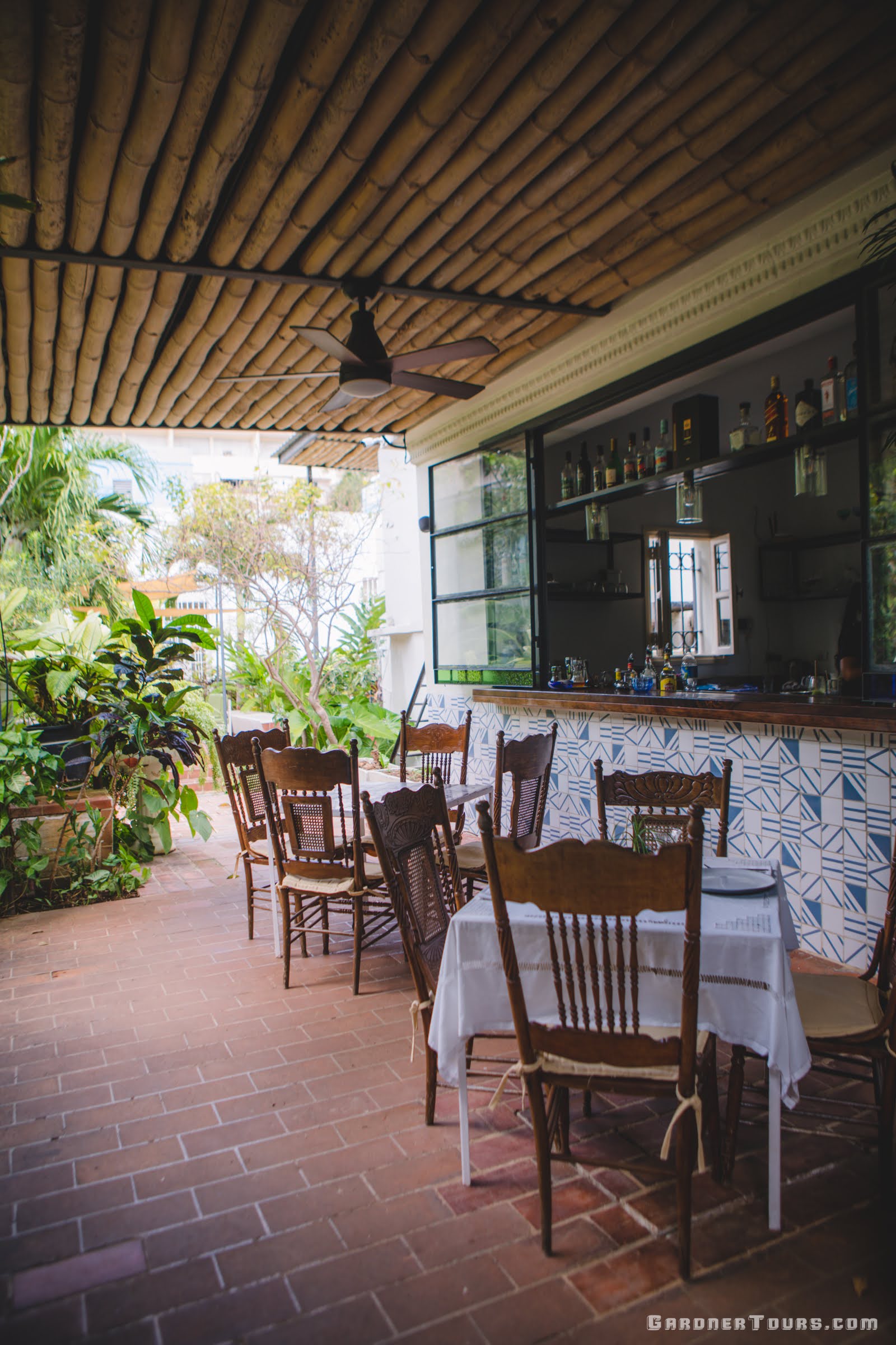 Relaxing Patio with Classic Chairs and Bar at 5-Star Restaurant Paladar La Bodega in Vedado, Havana, Cuba