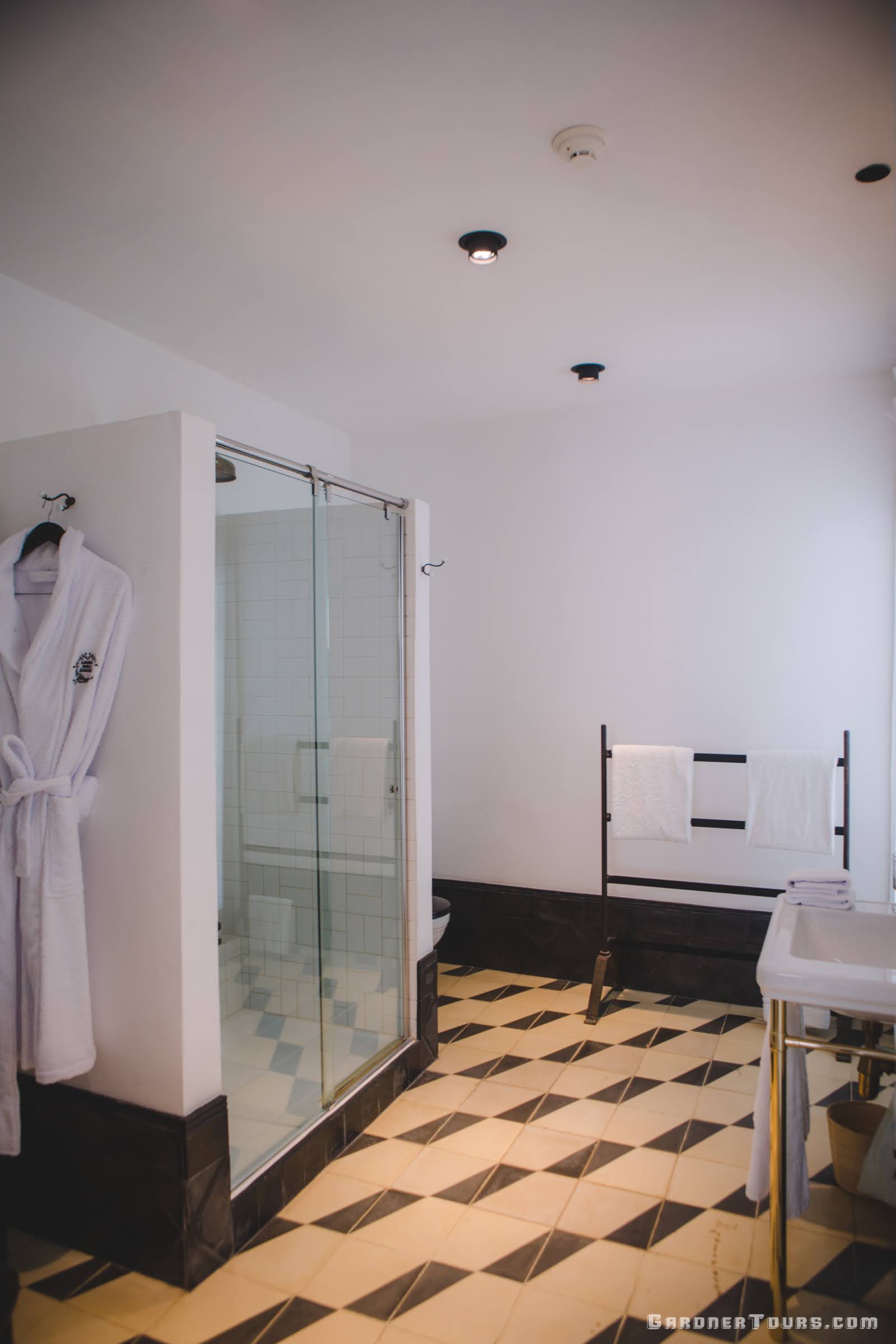 Luxurious Bathroom with Shower and Gold, Black, and White Decor in 5-star Luxury Accommodations in Old Havana, Cuba