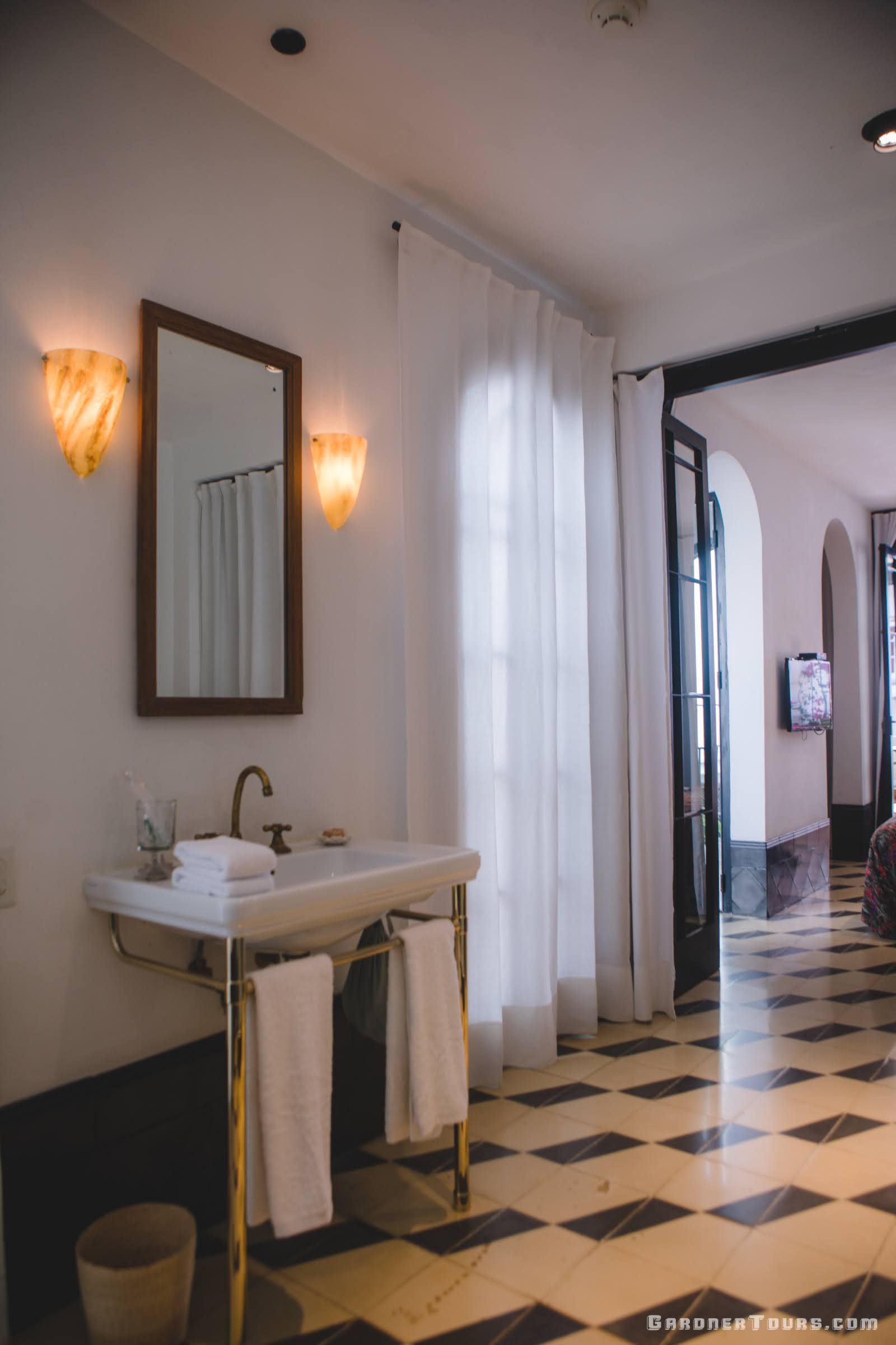 Amazing White and Gold Bathroom with Black and White tile in our 5-star Luxury Accommodations in Old Havana, Cuba
