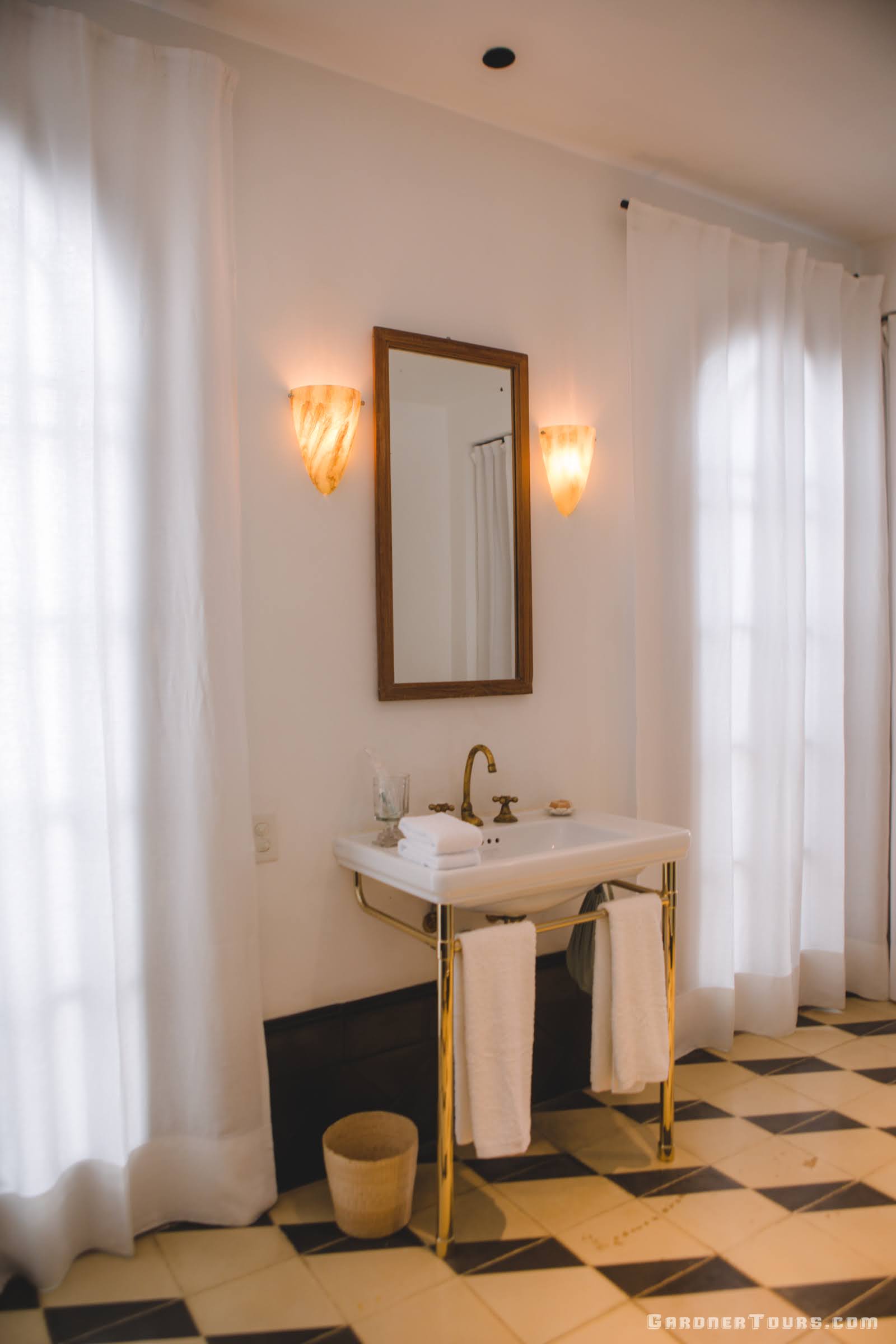 Luxurious Bathroom with Gold, Black, and White Decor in 5-star Luxury Accommodations in Old Havana, Cuba