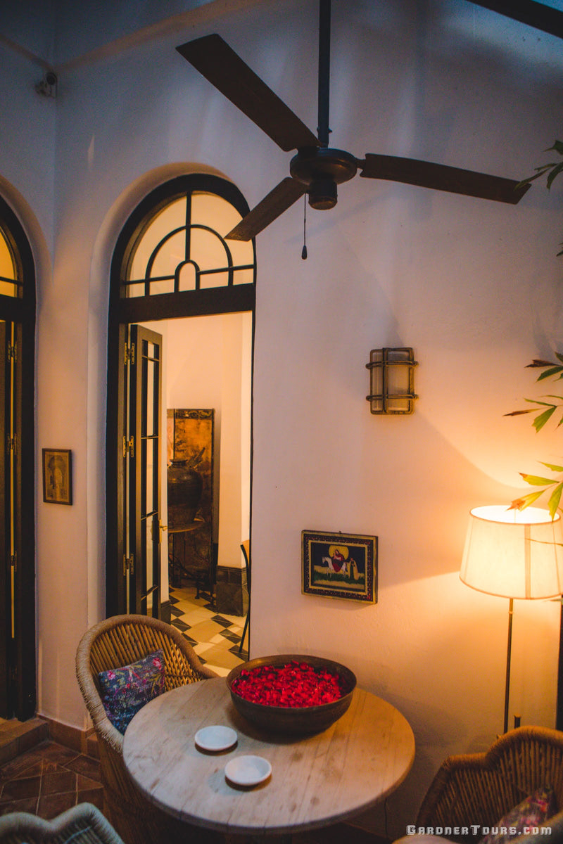 Sitting Area in Breezeway of Stairwell with Roses on the Table at 5-star Luxury Accommodations in Old Havana, Cuba