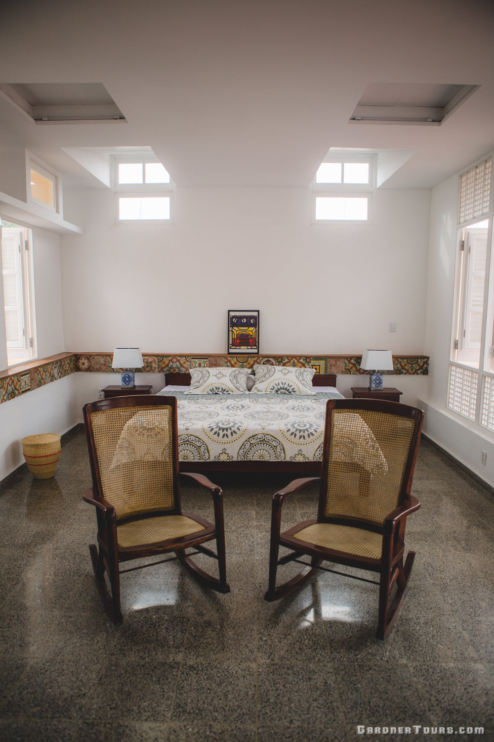 Gardner Tours spacious king size bed in a rooftop room with white walls and classic tiles at a 4-star BnB Casa Particular in Old Havana, Cuba