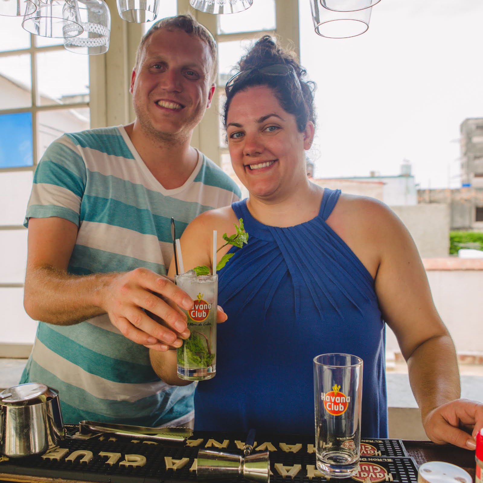 Gardner Tours Beautiful Couple Holding Mojitos at their Cocktail Lesson in Havana Cuba