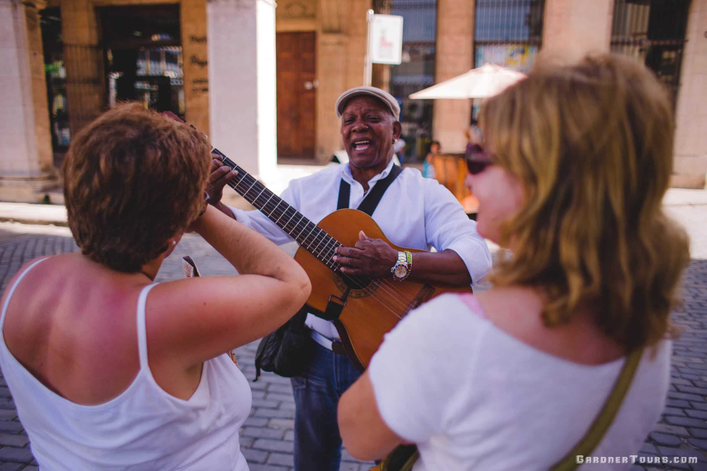 Street Performer singing to two Ladies in Old Havana, Cuba