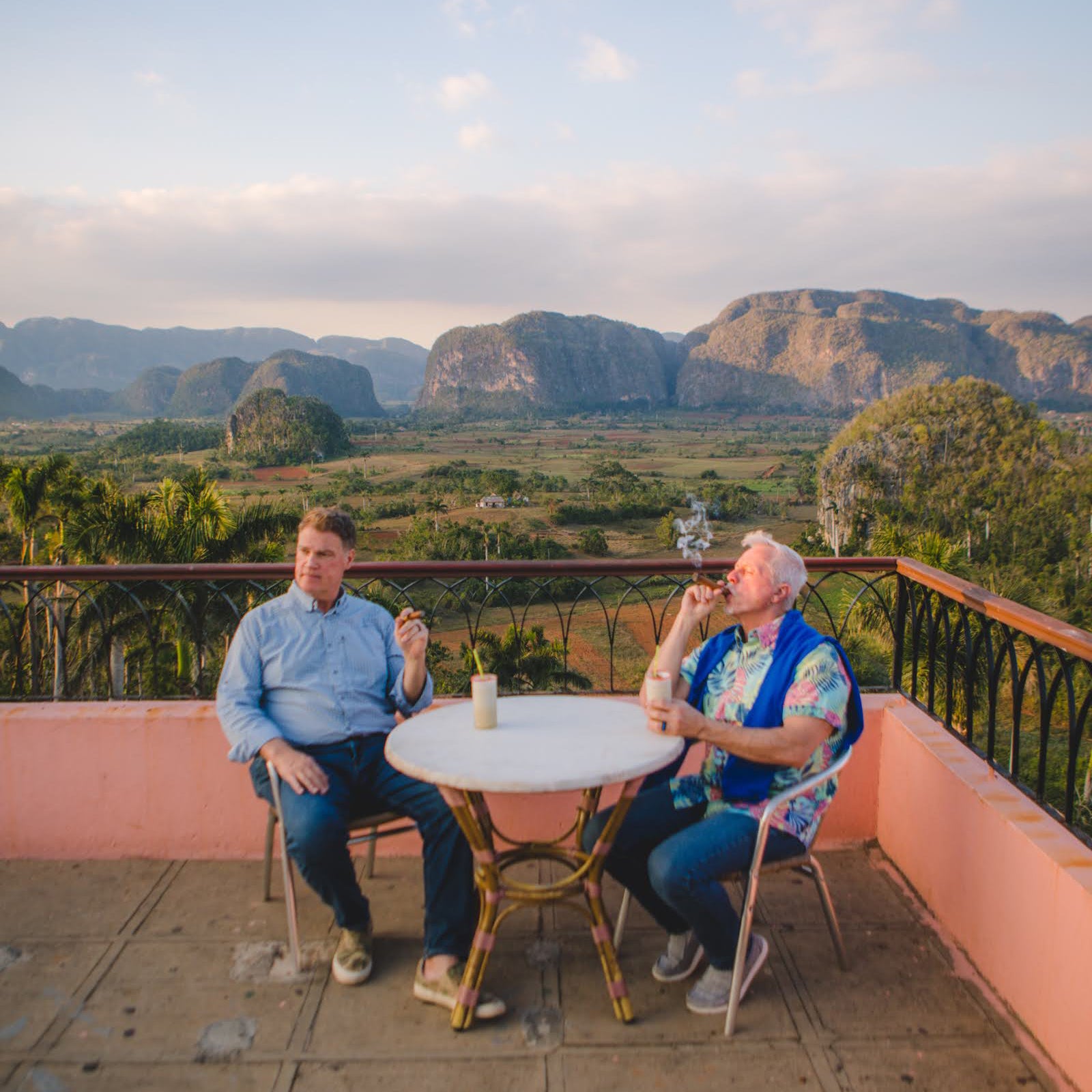 Gardner Tours Premium Cuba Cigar Tour Two Men dressed nicely and smoking cigars at the Viewpoint over Vinales Valley in Vinales Cuba