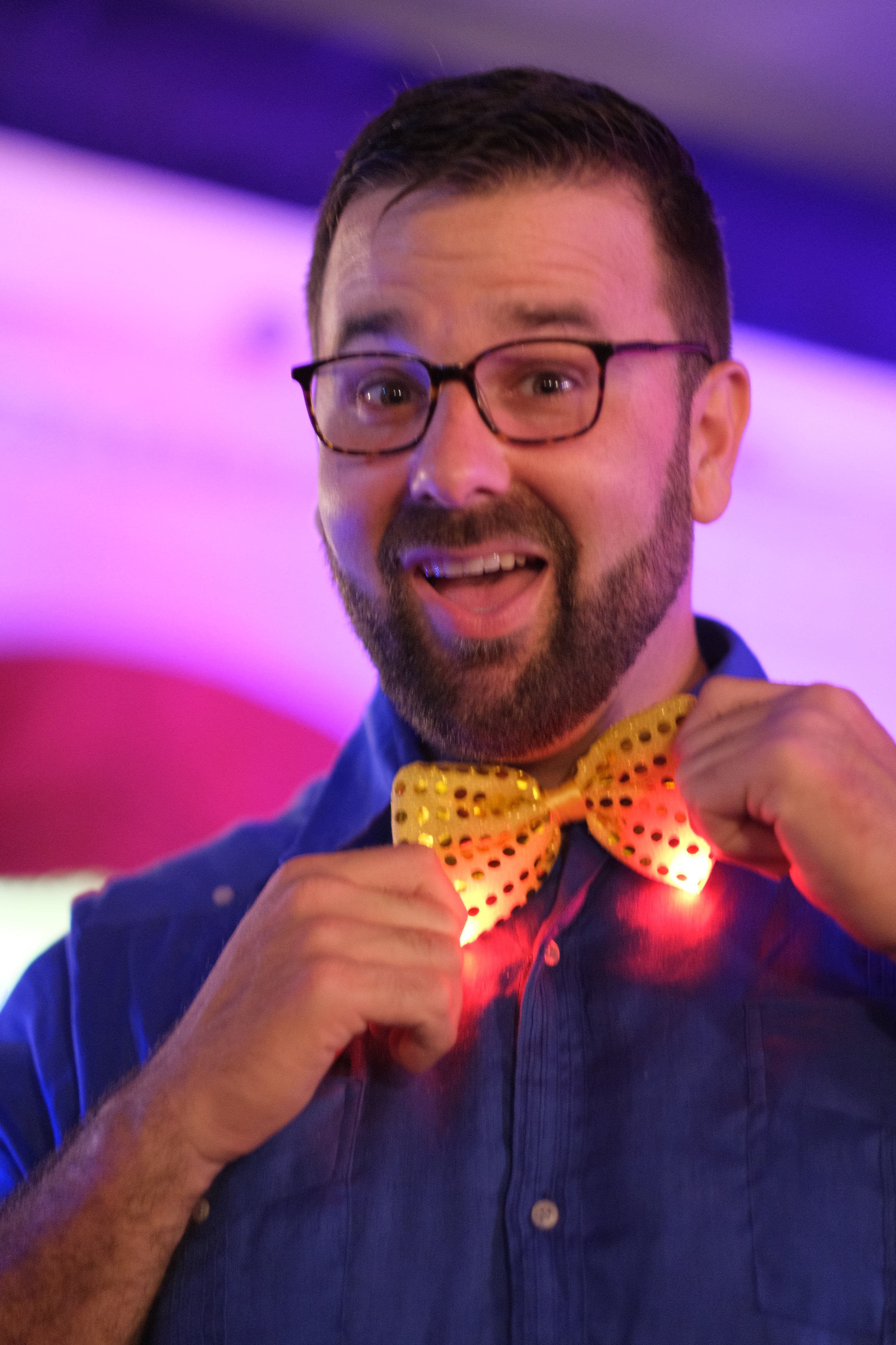 Gardner Tours Owner and Tour Guide Colby Gardner smiling big and twisting his bowtie at the big show in the Cabaret Parisien on New Years 2020 in Havana, Cuba