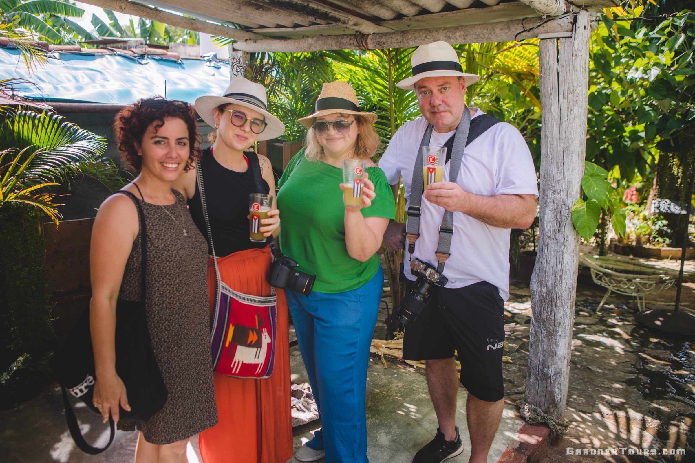 Gardner Tours Cuban Tour Guide Zeydi drinking guarapo with her travelers from Russia