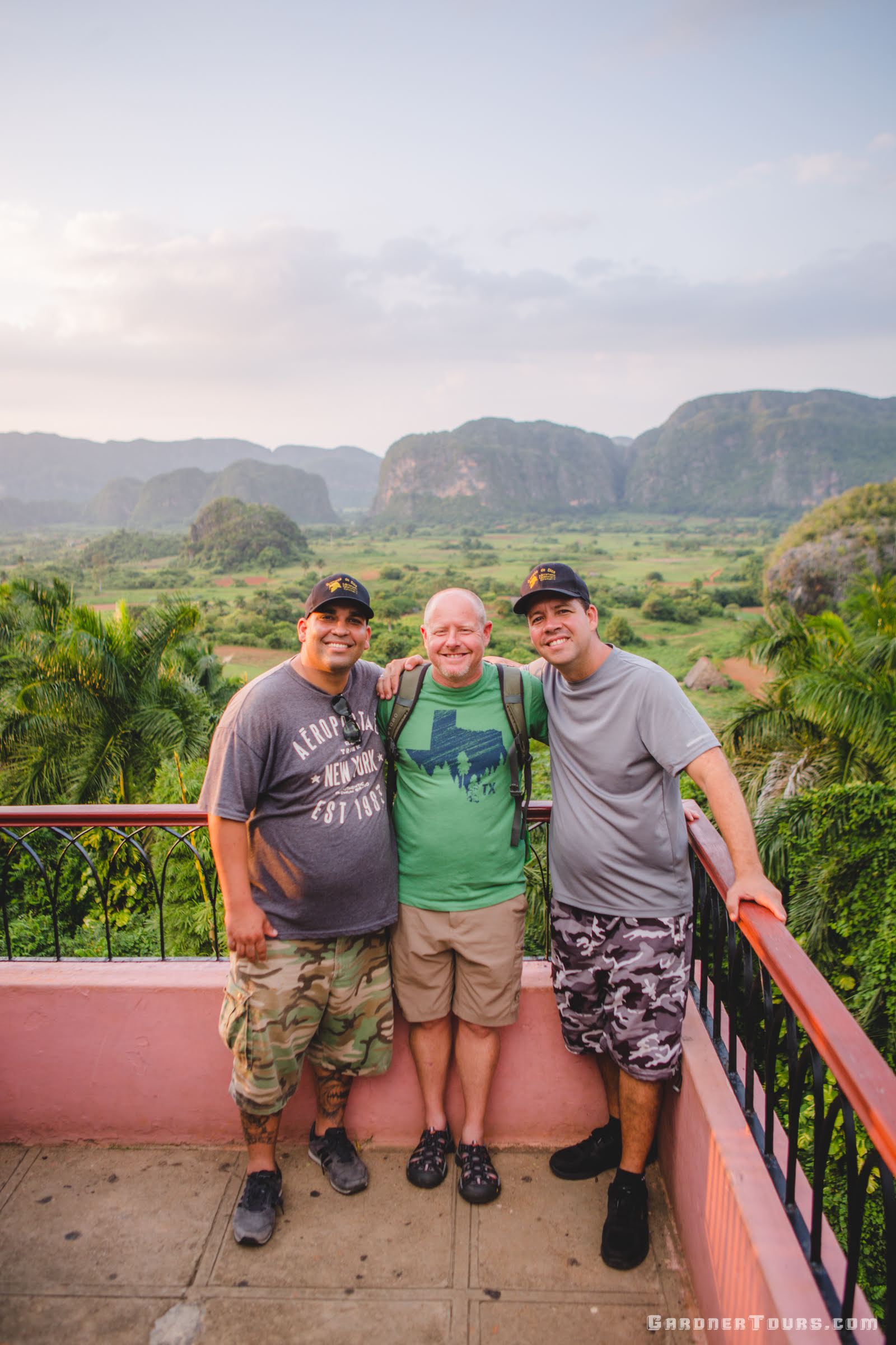 Gardner Tours Cuban Tour Guide Yunior and Albert smiling with a friend at the Viewpoint overlooking Viñales Valley in Cuba