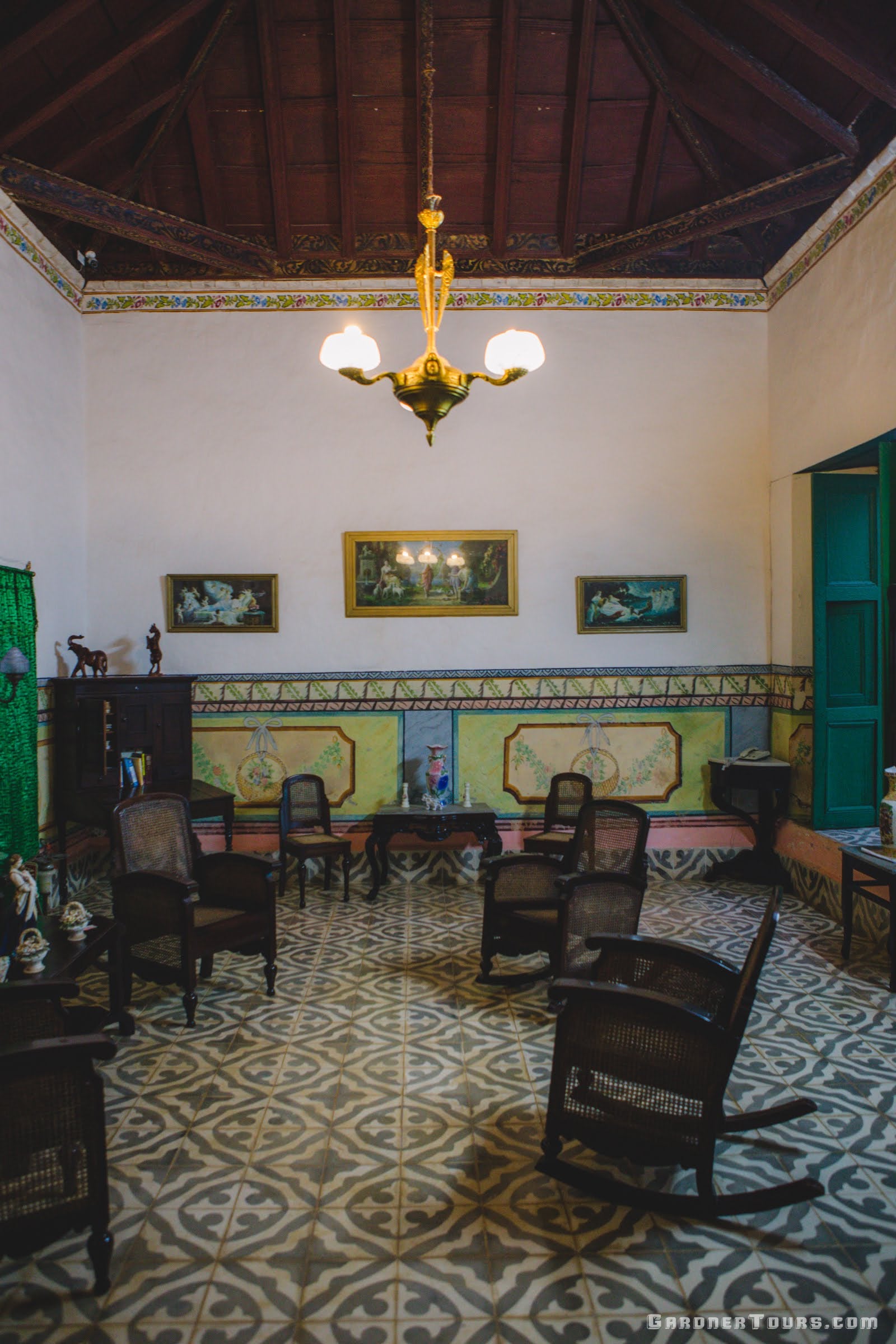 Classic 1700s colorful green and white Living Room Sala in a 3-star Casa Particular BnB in Trinidad, Cuba
